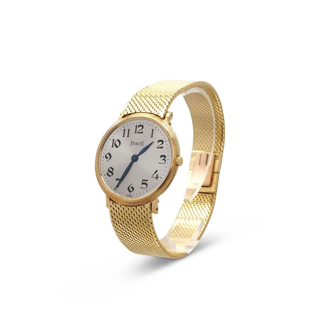 Authentic Piaget vintage watch crafted in 18 karat yellow gold features a bezel with richly designed triple row of hobnail, with a thin, solid mesh bracelet attached to the rounded lugs that wrap beautifully around the wrist.  Showcasing a vintage