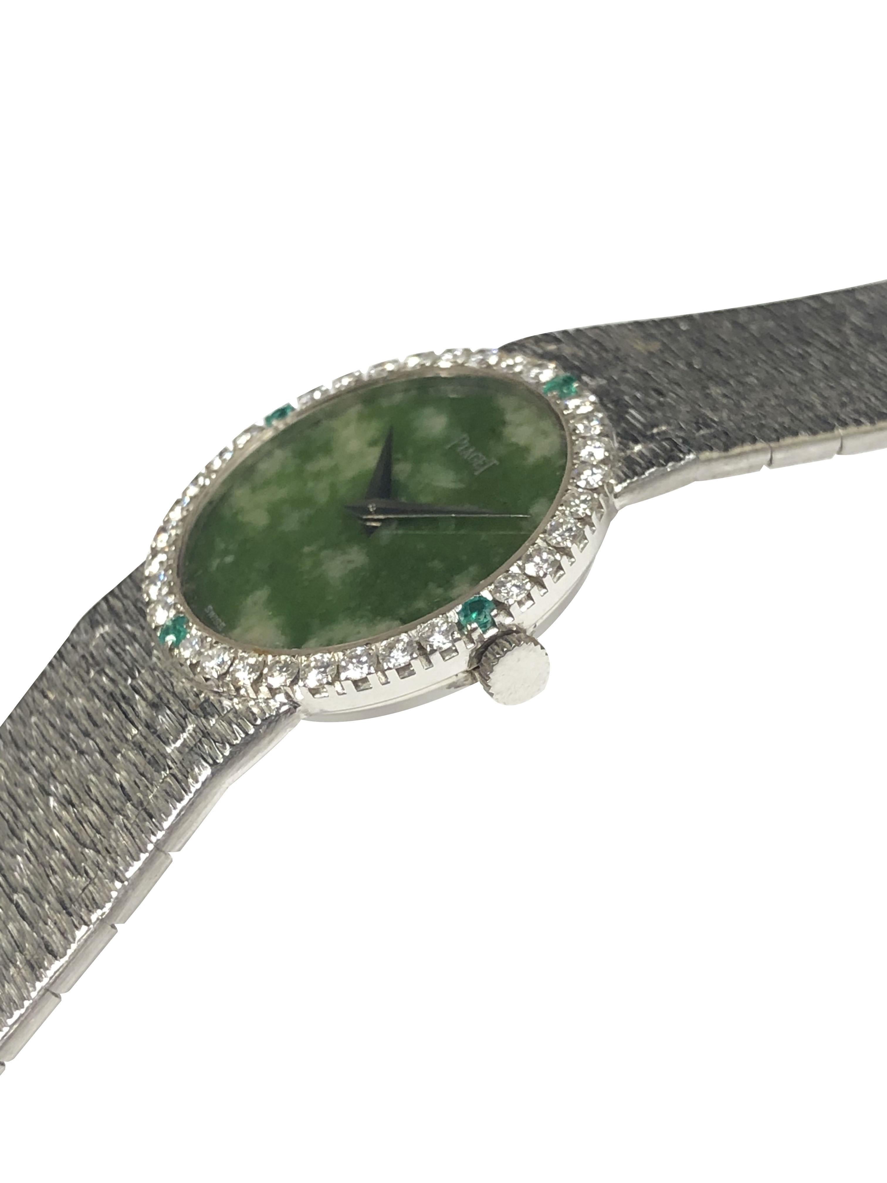 Circa 1980 Piaget Ladies Wrist Watch, 24 M.M. 18K White Gold 2 Piece case with White Gold Bezel set with Round Brilliant cut Diamonds totaling 1 Carat and further set with 4 Very fine Color Emeralds. 17 Jewel Mechanical, Manual wind 17 Jewel