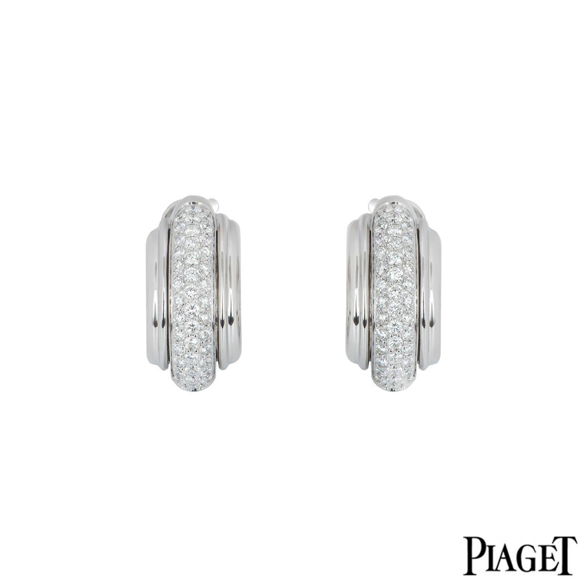 An 18k pair of white gold diamond earrings by Piaget from the Possession collection. The earrings are each set with 46 round brilliant cut diamonds through the middle with a total approximate weight of 1.04ct with fluted borders beside it. The