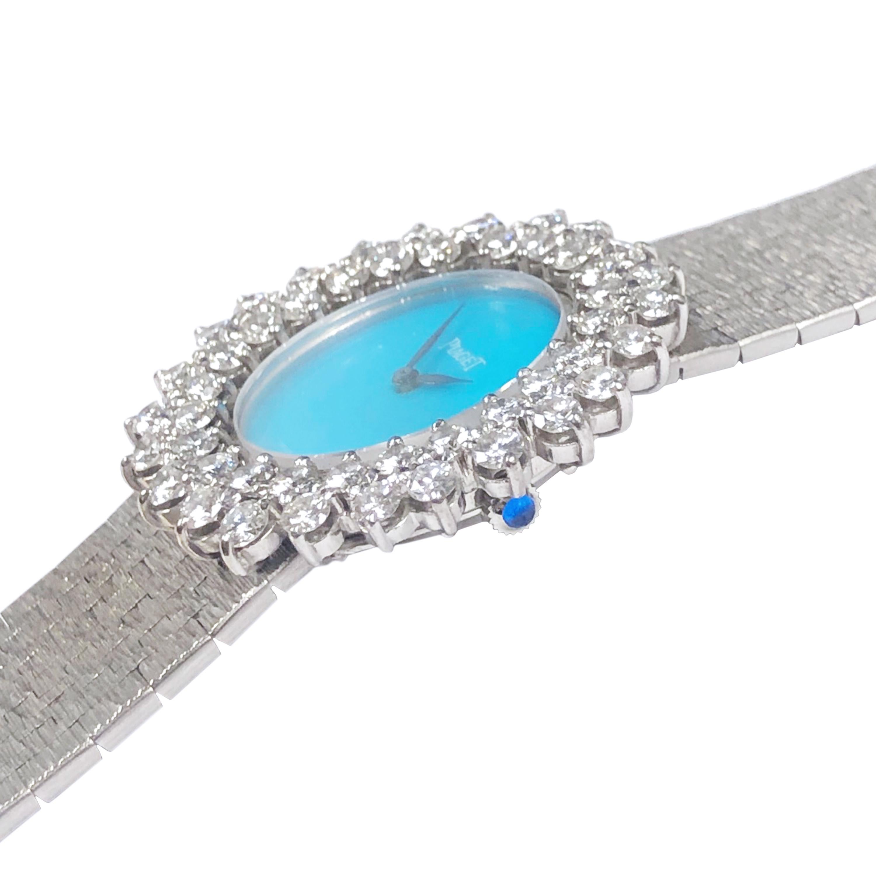 Circa 1980 Piaget ladies 18K White Gold Wrist watch, Piaget factory double row Diamond bezel of Round brilliant cut Diamonds grading as G in Color VS in Clarity and totaling 3.50 Carats. 17 jewel mechanical, manual wind movement, Turquoise stone