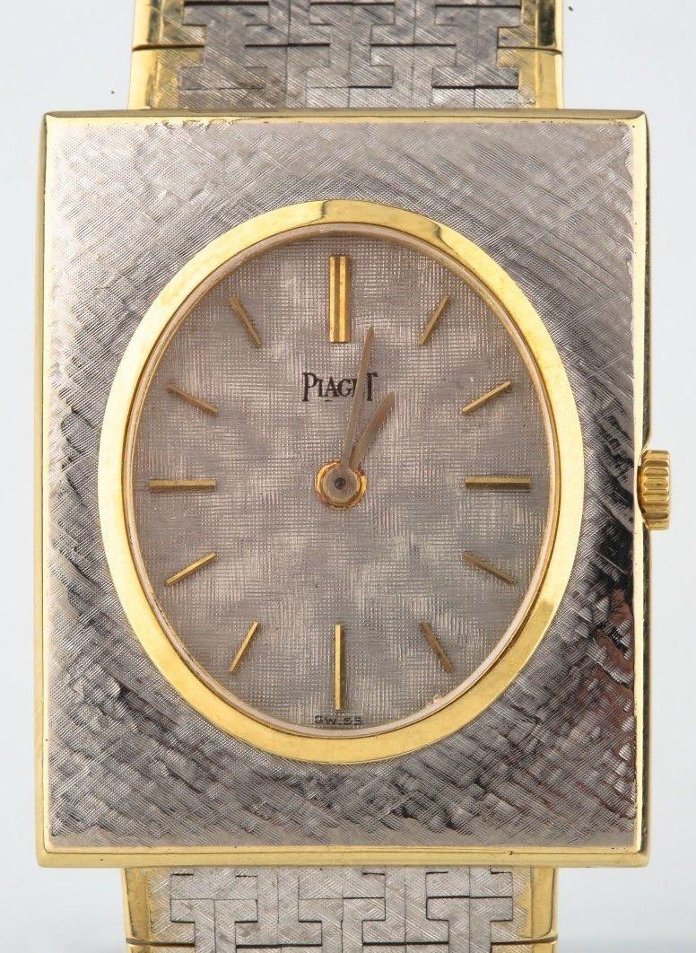 Movement #9.P.610983
Case #916A3-74420
Solid 18k White Gold Textured Case w/ Yellow Gold Bezel & Rim
23 mm Wide (25 mm w/ Crown)
30 mm Long
Thickness = 4 mm (ULTRA-THIN)
Silver Textured Oval Dial w/ Gold Tic Marks and Silver Hands (M + H)
Labeled