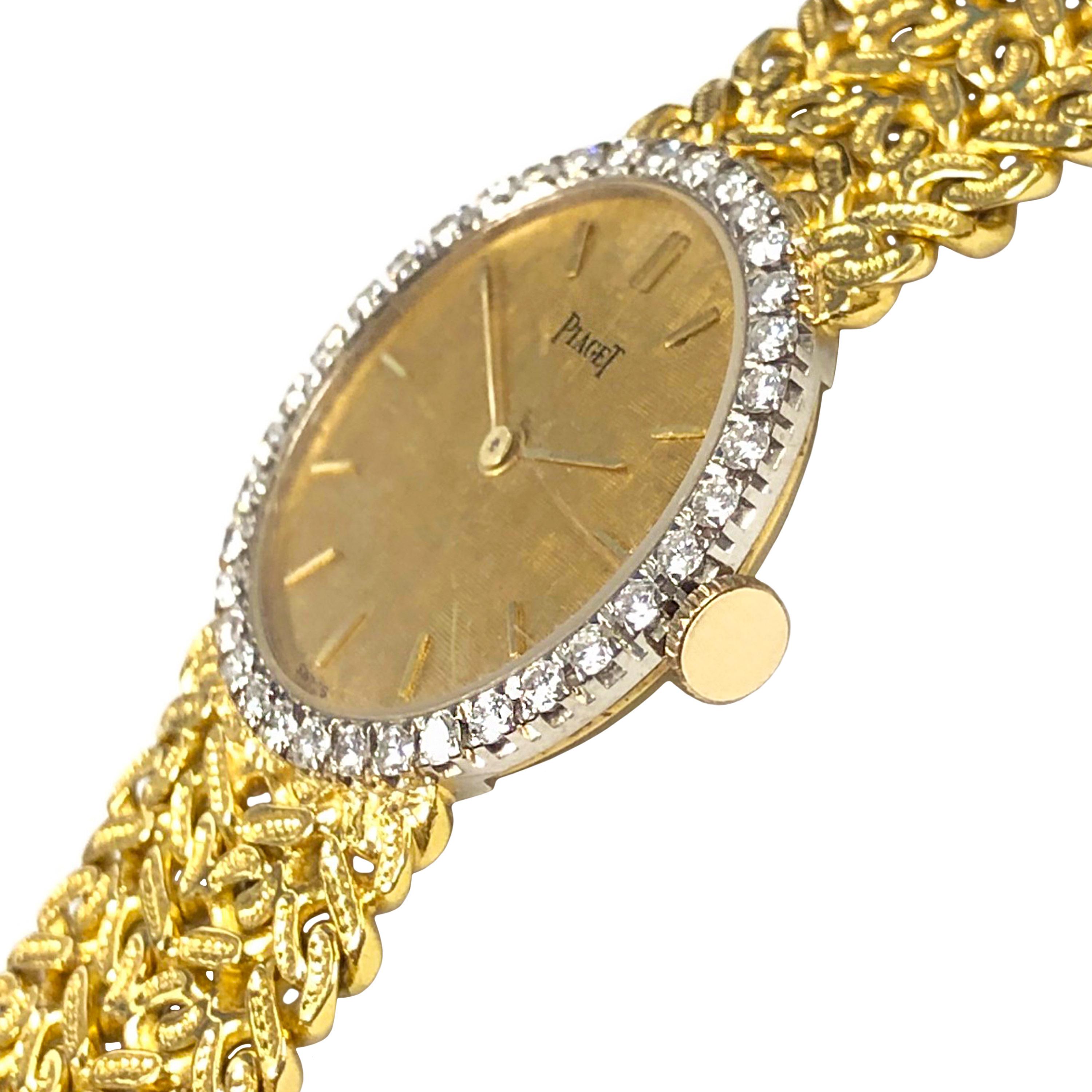 Circa 1970s Piaget Ladies Wrist Watch, 24 MM 2 Piece 18K Yellow Gold case with White Gold Bezel set with Round Brilliant cut Diamonds totaling 1 Carat. Mechanical, Manual wind 17 jewel Movement, Gold textured dial with raised Gold markers. 5/8 inch