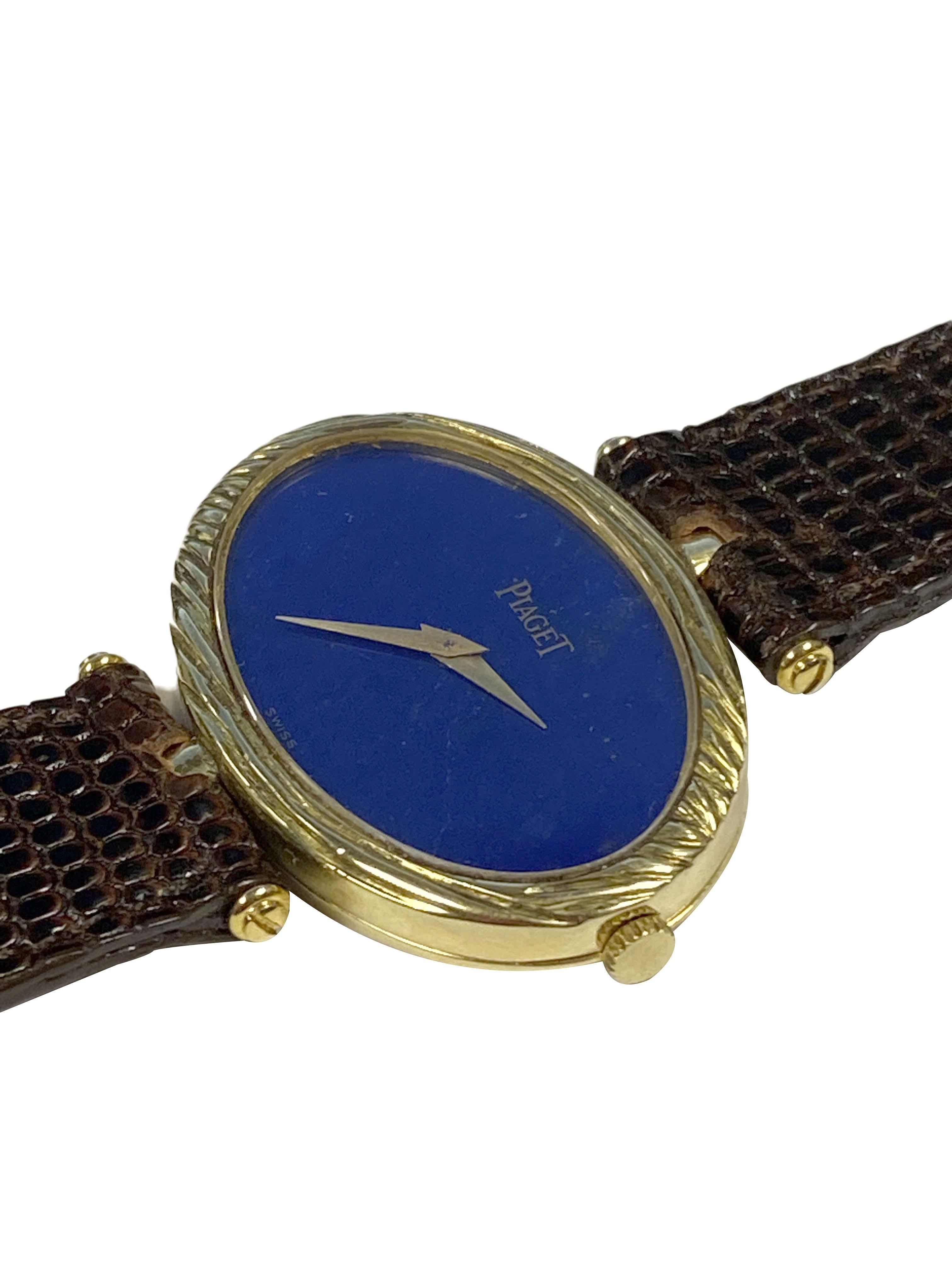 Circa 1970s Piaget Ladies Wrist Watch, 18k Yellow Gold 2 Piece oval case with Textured bezel measuring 34 X 23 M.M. 17 Jewel, mechanical, Manual wind movement. Lapis Lazuli Dial with Gold hands. New Brown Lizard Strap. Recently serviced and comes