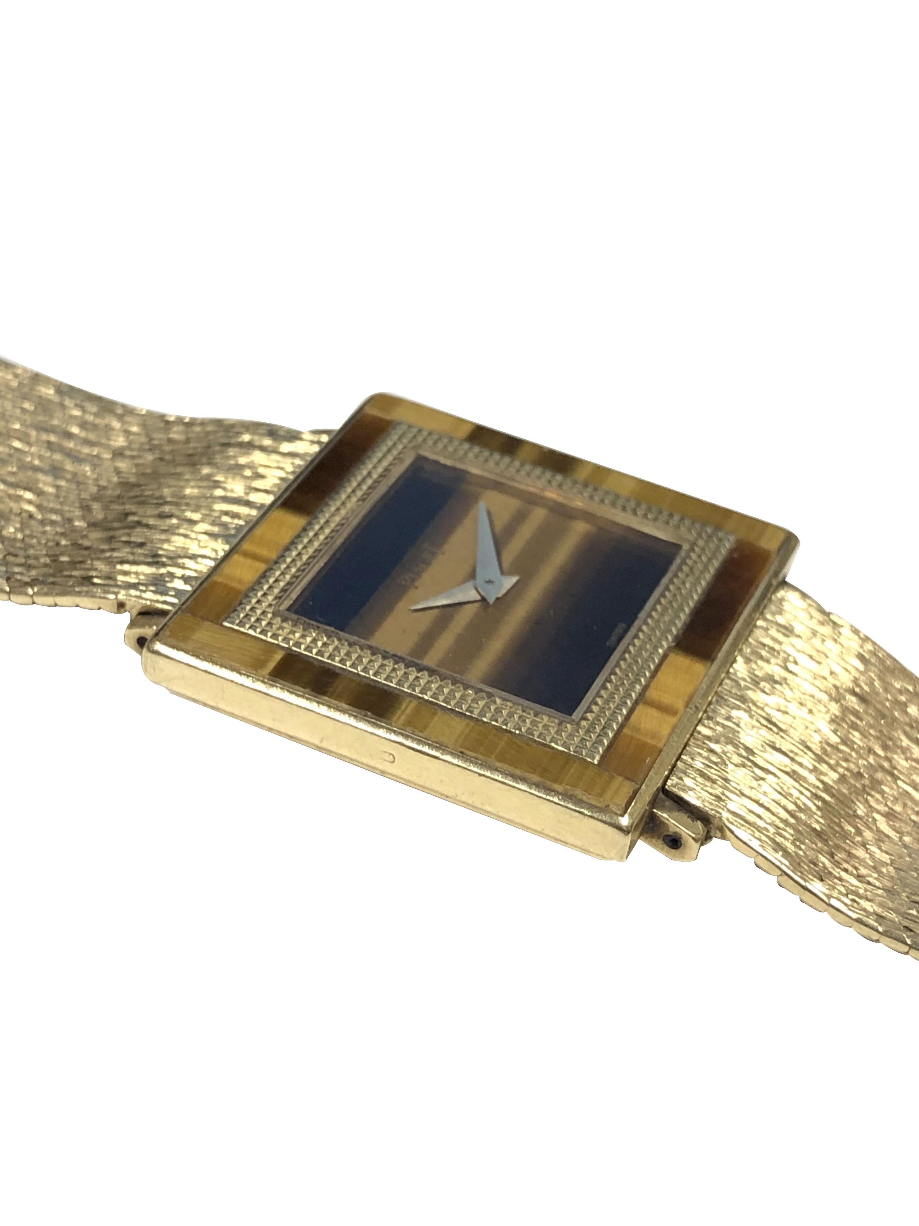 Circa 1980 Piaget Wrist Watch, 25 X 25 M.M. 2 Piece 18K Yellow Gold case with Tigers Eye set Bezel, 17 Jewel Mechanical, Manual Wind Movement, Tigers Eye Dial, Yellow Gold Hands. 3/4 inch wide detachable soft Mesh Bracelet. Watch length 7 1/4