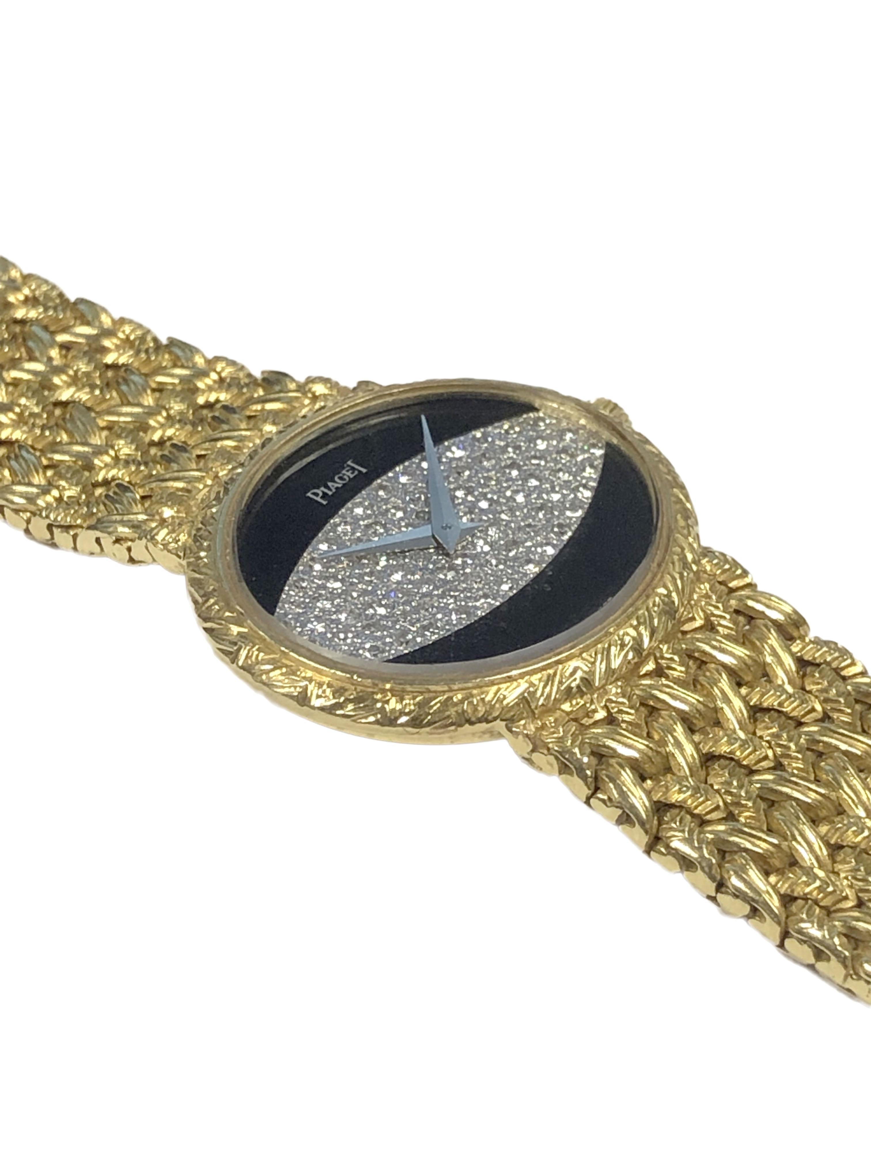 Circa 1970 Piaget Ladies Wrist Watch, 27 x 24 M.M. 18k Yellow Gold 2 piece Oval case with textured bezel, Onyx and Diamond Pave dial, 17 jewel mechanical, manual wind movement.  attached soft mesh woven flexible bracelet with Piaget signed clasp.