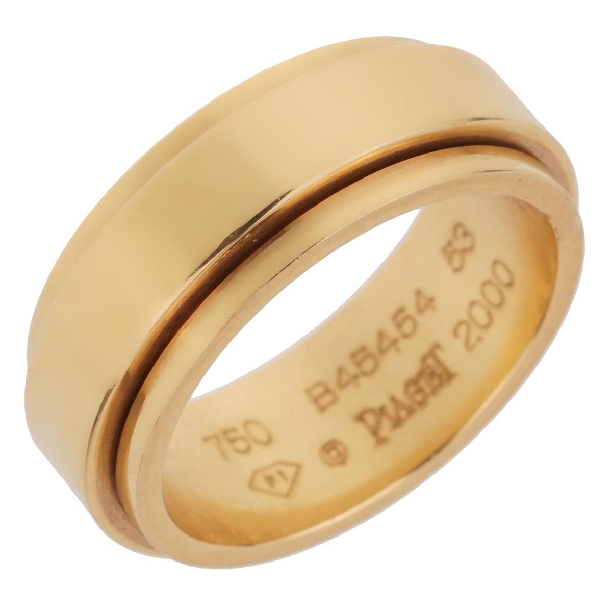 An iconic Piaget Possession yellow gold spinning ring in 18k yellow gold. The ring measures size 6 1/2