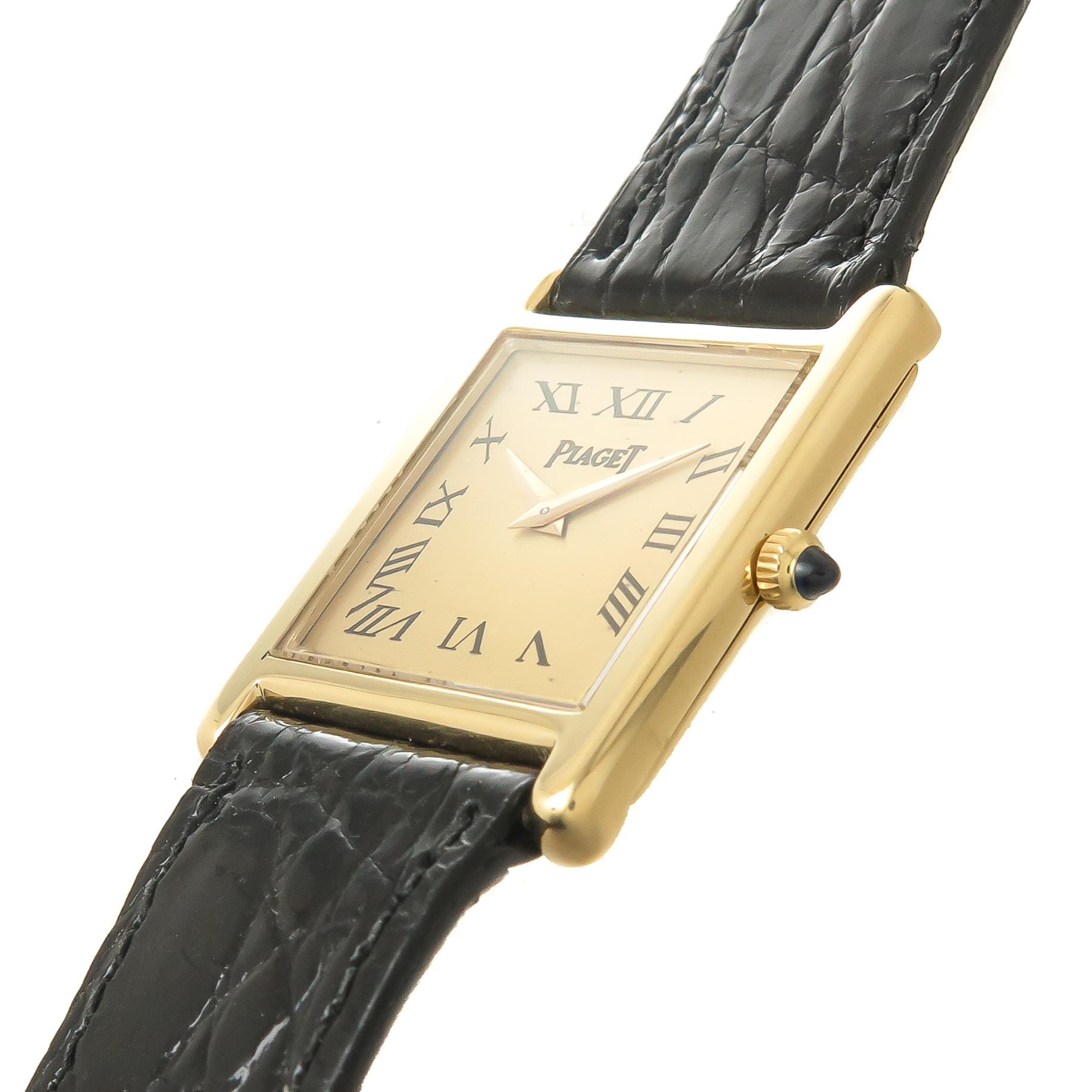 Circa 1990 Piaget Tank Wrist watch, 29 X 22 MM 18K Yellow Gold case, 17 Jewel manual wind, mechanical movement. Gold Dial with Black Roman numerals and Gold Hands, sapphire crown. New Black Alligator Piaget strap and original 18K yellow Gold Piaget