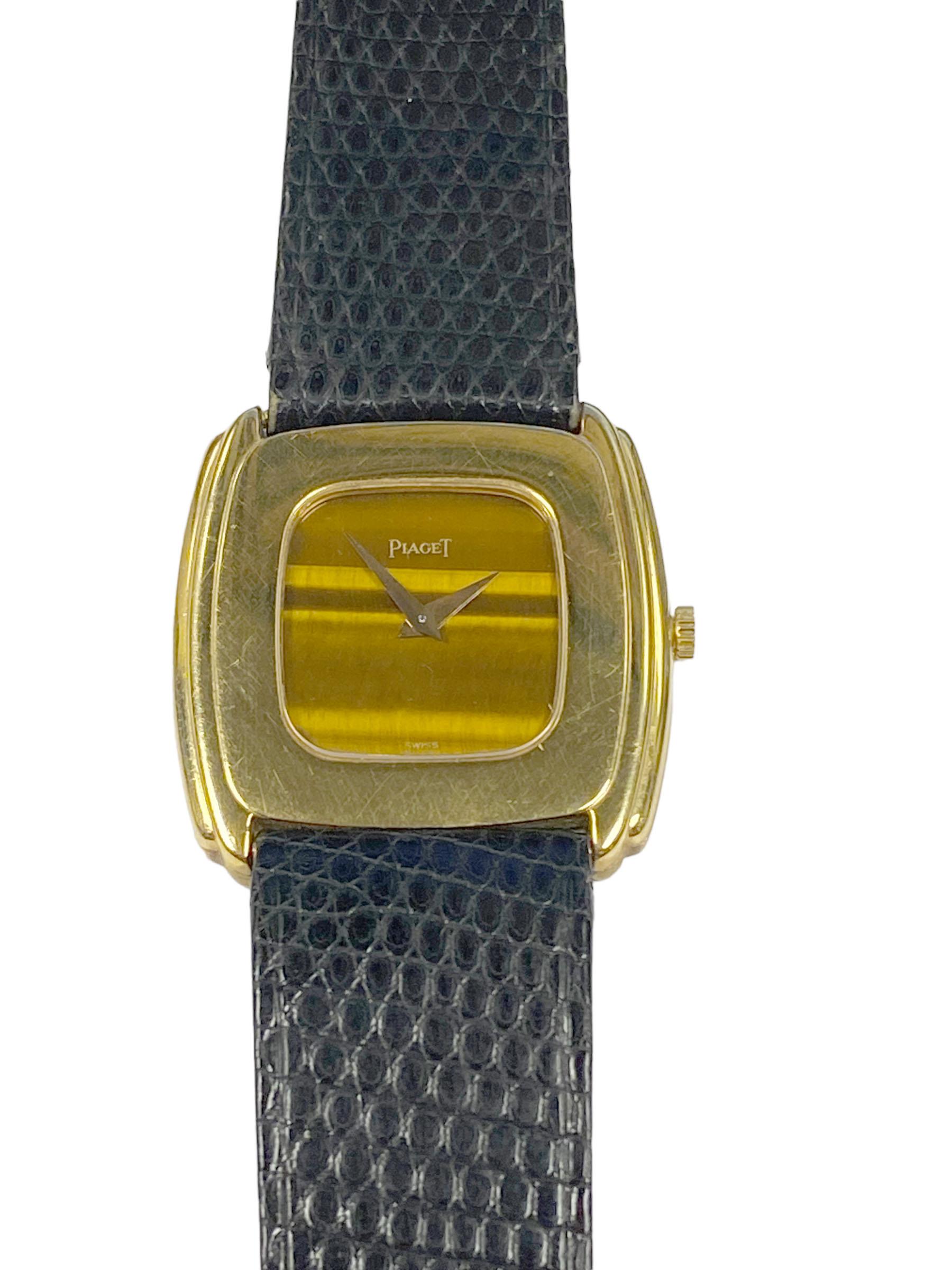 Circa 1980 Piaget Wrist Watch, 29 X 26 M.M. 18k Yellow Gold 2 piece stepped case. 17 jewel mechanical, manual wind movement. Tiger Eye Dial, original Piaget Black Lizard strap, Piaget 18k Gold buckle. Watch length 8 1/4 inches. 