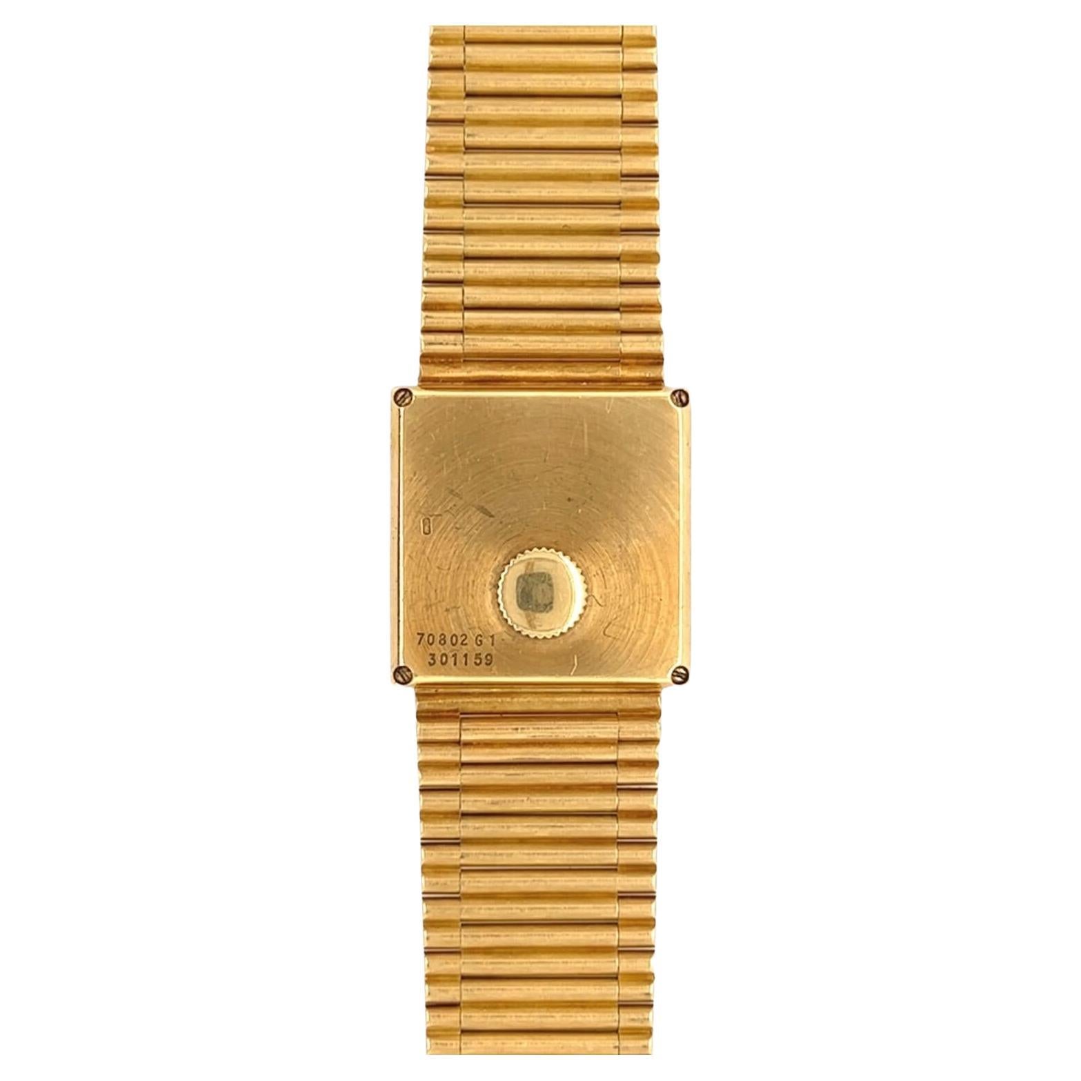 An 18 karat yellow gold watch, Piaget.  The square gold dial with dot markers for the hours and minutes within a simple square bezel measuring approximately 23 mm, completed by a bracelet of bar links.  Quartz movement.  Signed Piaget on the dial