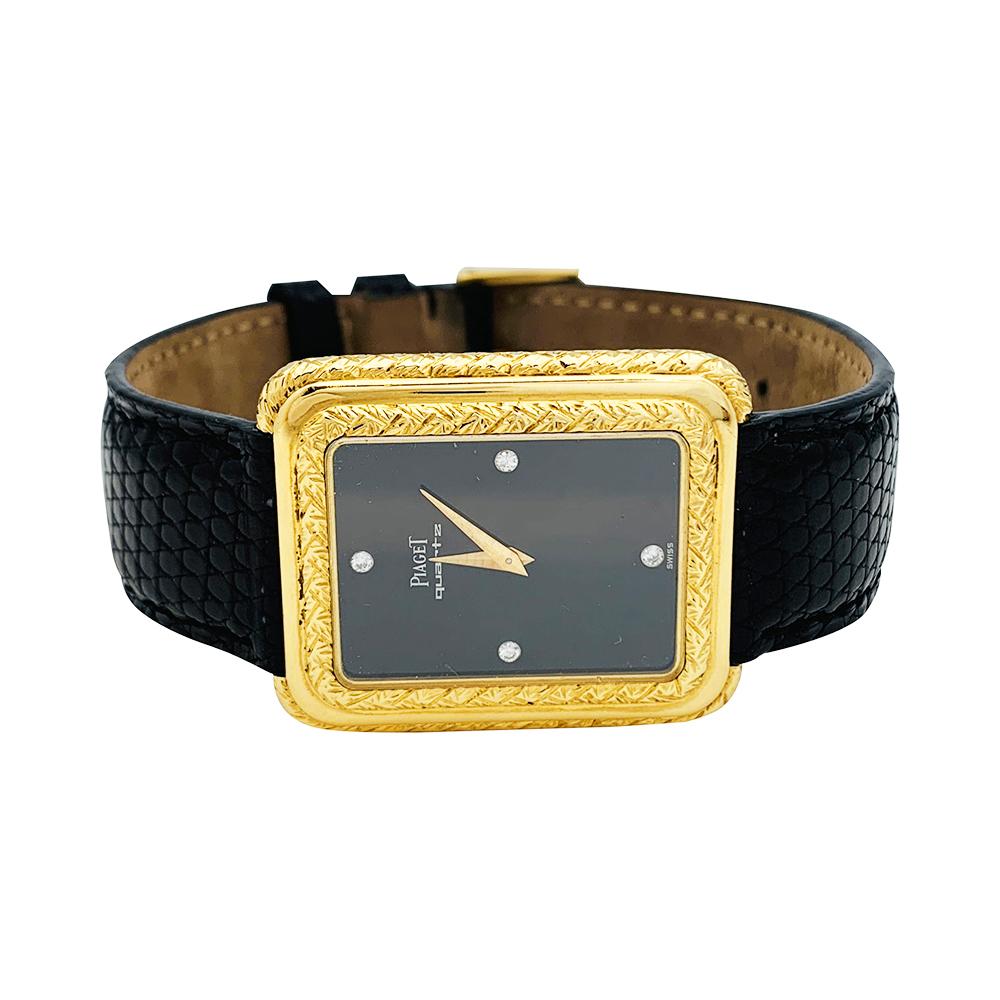 A 18K yellow gold Piaget vintage watch, set on a leather bracelet (not Piaget) with a Piaget 18K yellow gold pin buckle. 
Black dial, 4 diamonds index. 
Quartz movement.
Circa 1980's