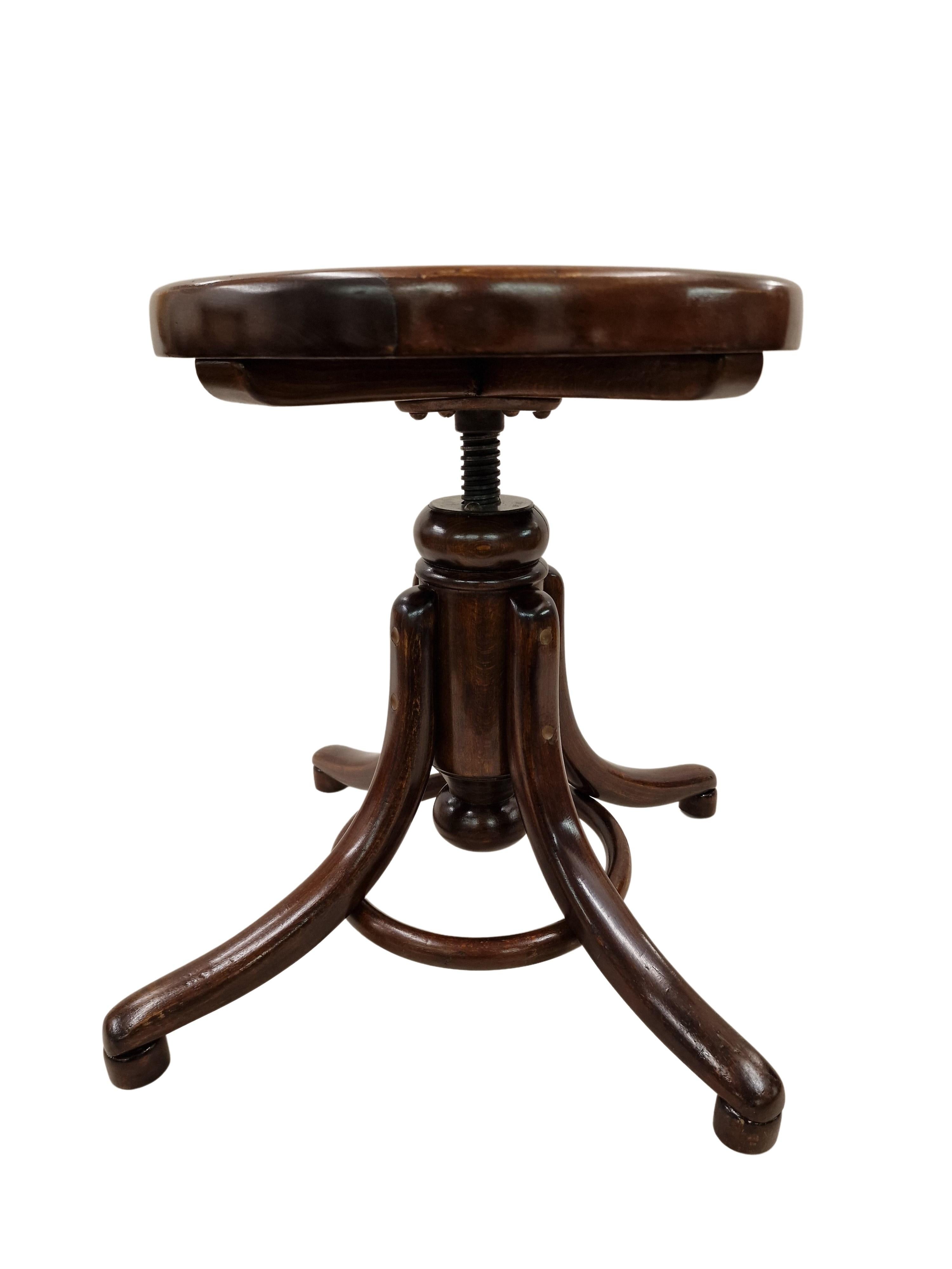 The famous piano stool of the renowned bentwood furniture manufacturer Thonet in Austria.
An original of the time from 1890 to 1900, Jugendstil, out of bentwool (beech), stained to resemble walnut.
The round seat forms a wonderful contrast to the