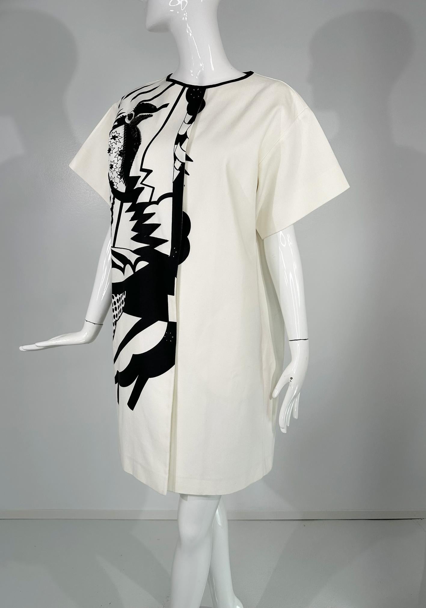 Piazza Sempione black & white pop art, cotton canvas, smock dress marked size 46. Jewel neck, short full sleeves and large hidden snap front closure. Yoke back with a center inverted pleat.  Unique pop art inspired black print at the right front and