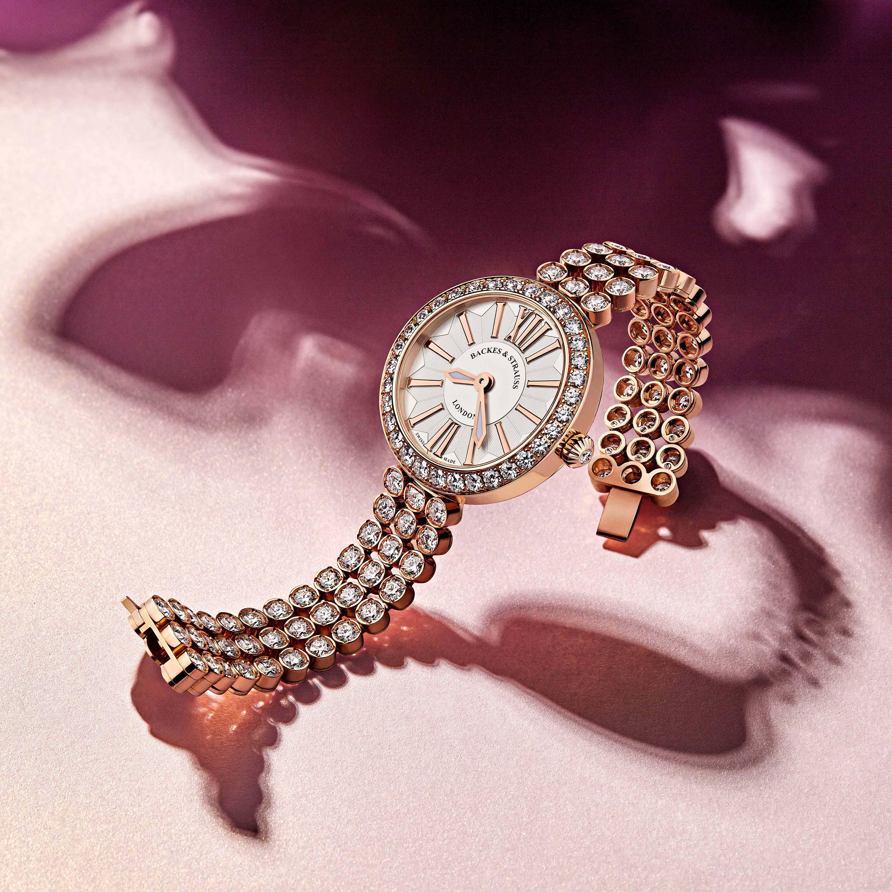 Piccadilly Duchess 33 is a luxury diamond watch for women crafted in 18kt Rose gold, featuring the round mother-of-pearl dial with the rose gold roman numerals, quartz movement. The case, dial and the crown are set with white Ideal Cut diamonds. It