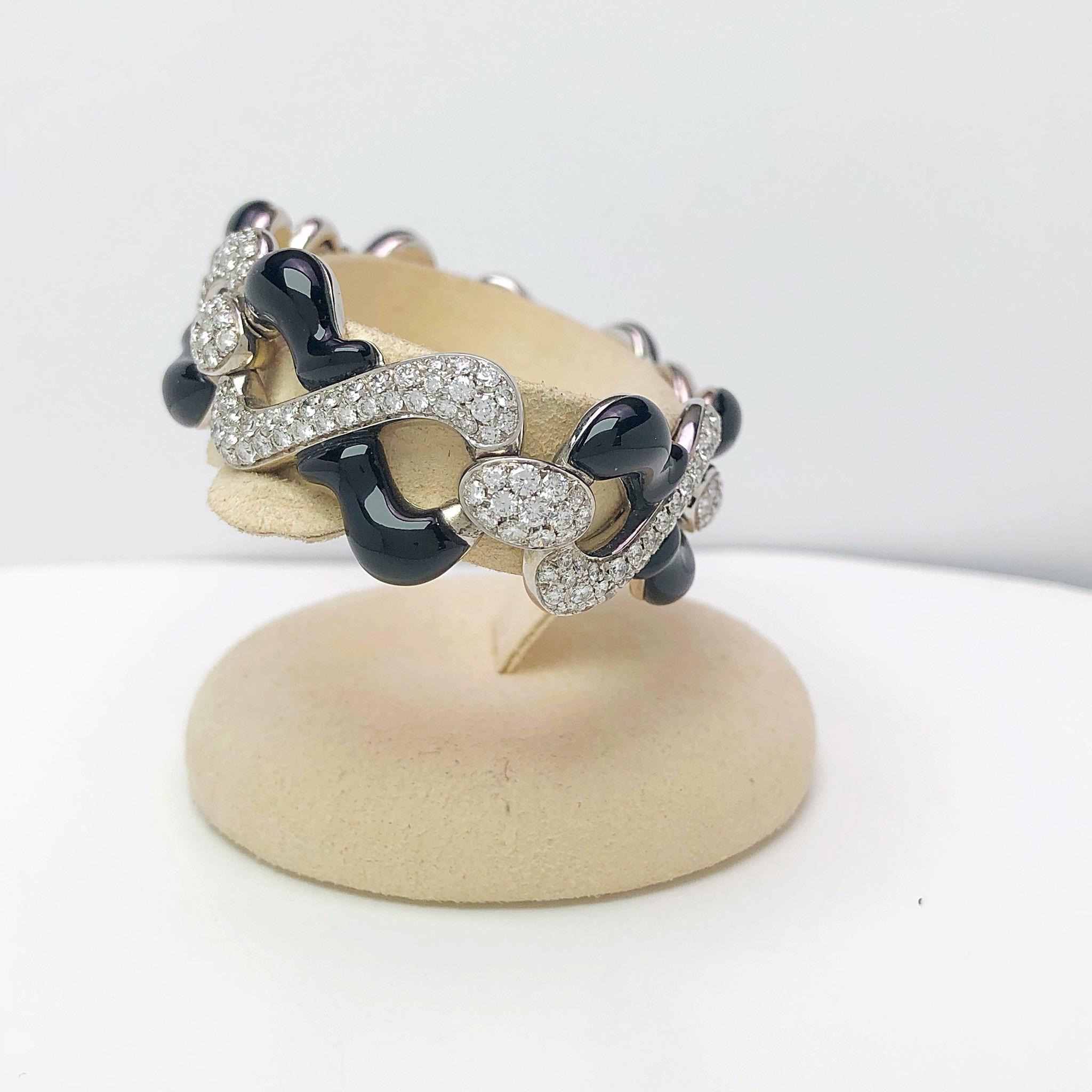 Designed by the renowned luxury jeweler Giuseppe Picchiotti ,this diamond and onyx bracelet are clear examples of his iconic style. Free formed flat links of 18 karat white gold are pave set with round brilliant diamonds and black onyx for a