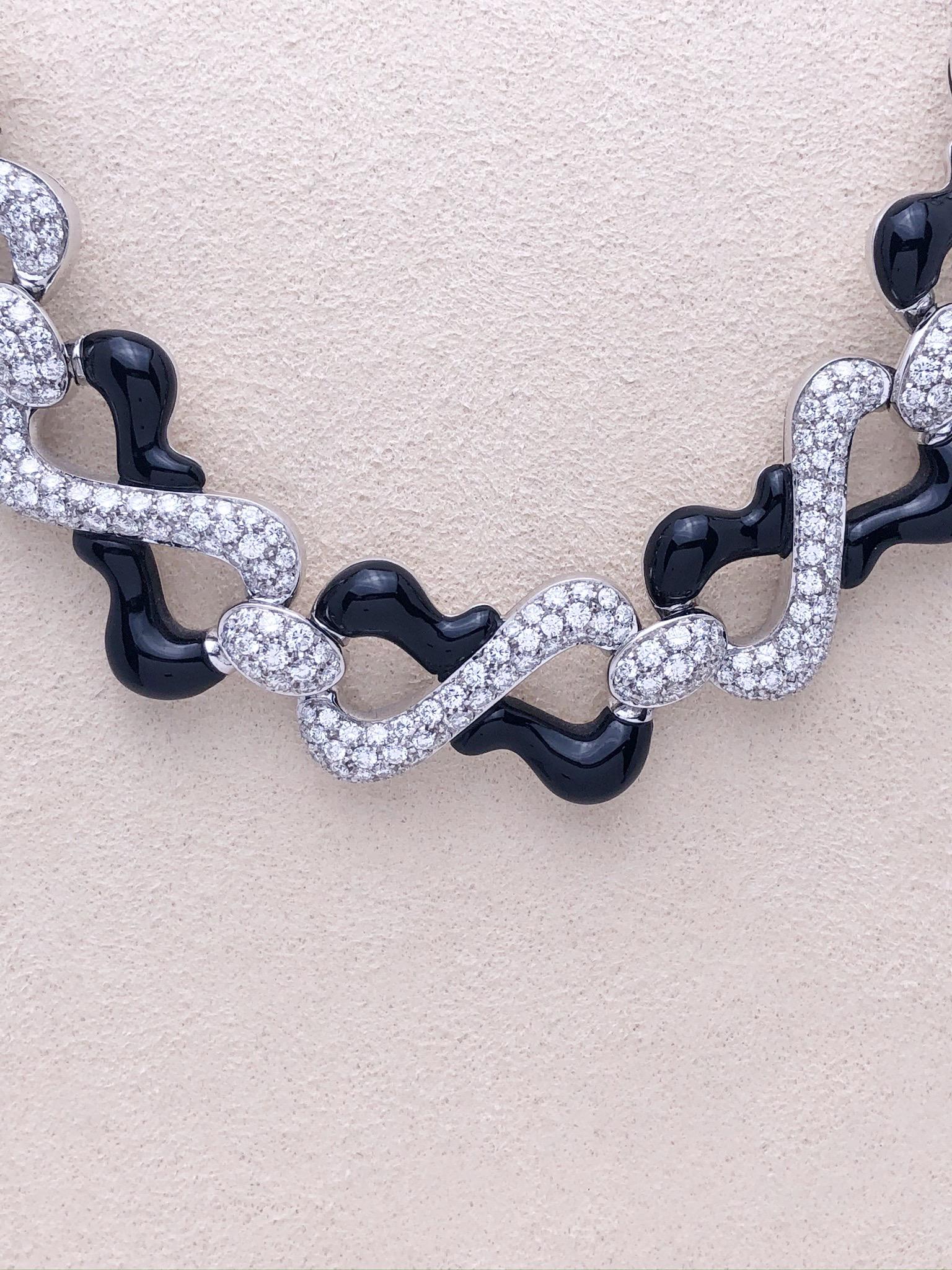 Designed by the renowned luxury jeweler Giuseppe Picchiotti ,this diamond and onyx necklace are clear examples of his iconic style. Free formed flat links of 18 karat white gold are pave set with round brilliant diamonds and black onyx for a