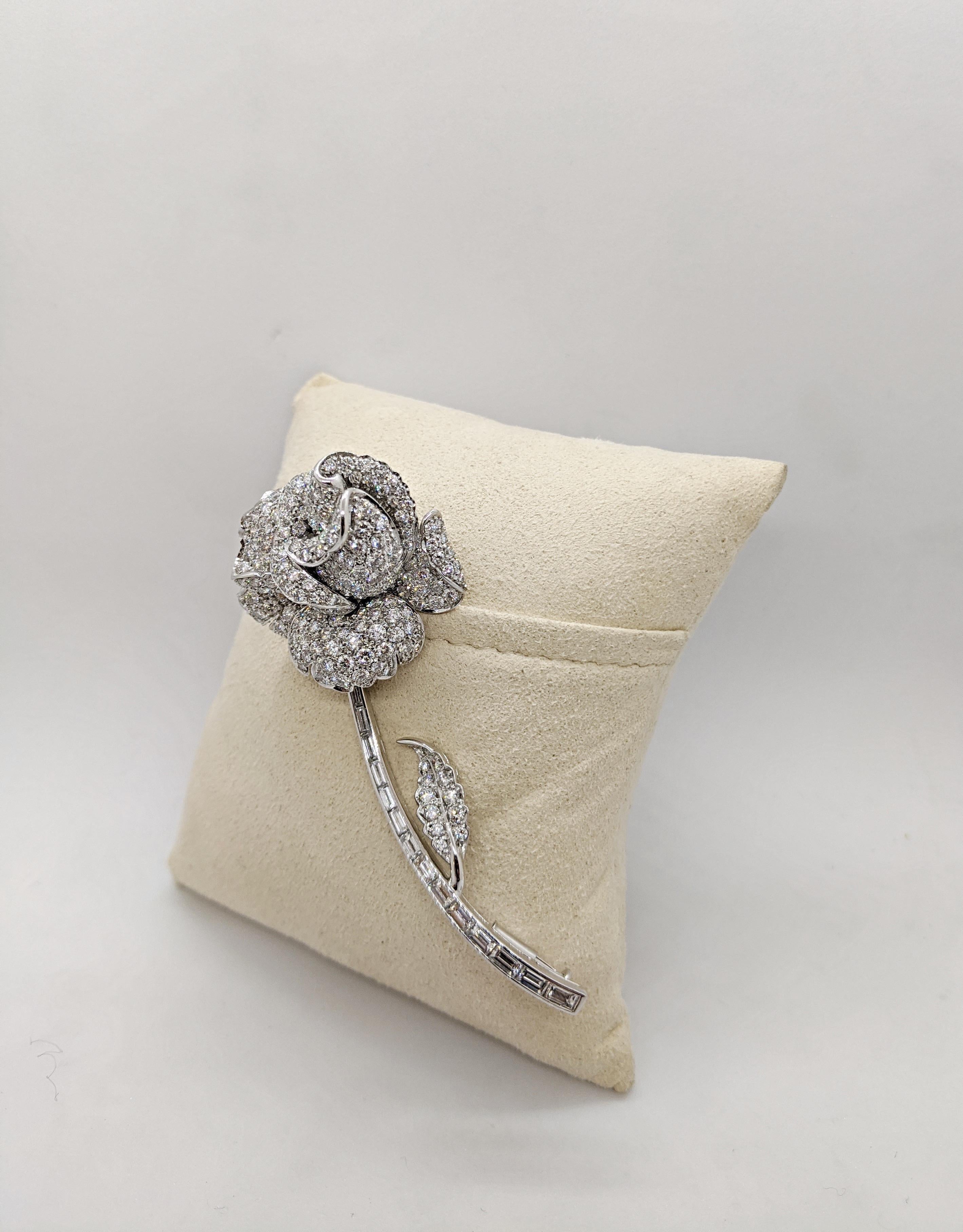Crafted by the famed Italian designer Guiseppe Picchiotti, this brooch is a perfect example of his meticulous work. Set in 18 karat white gold this brooch is designed as a beautiful single rose. The exquisitely sculpted petals are set with round