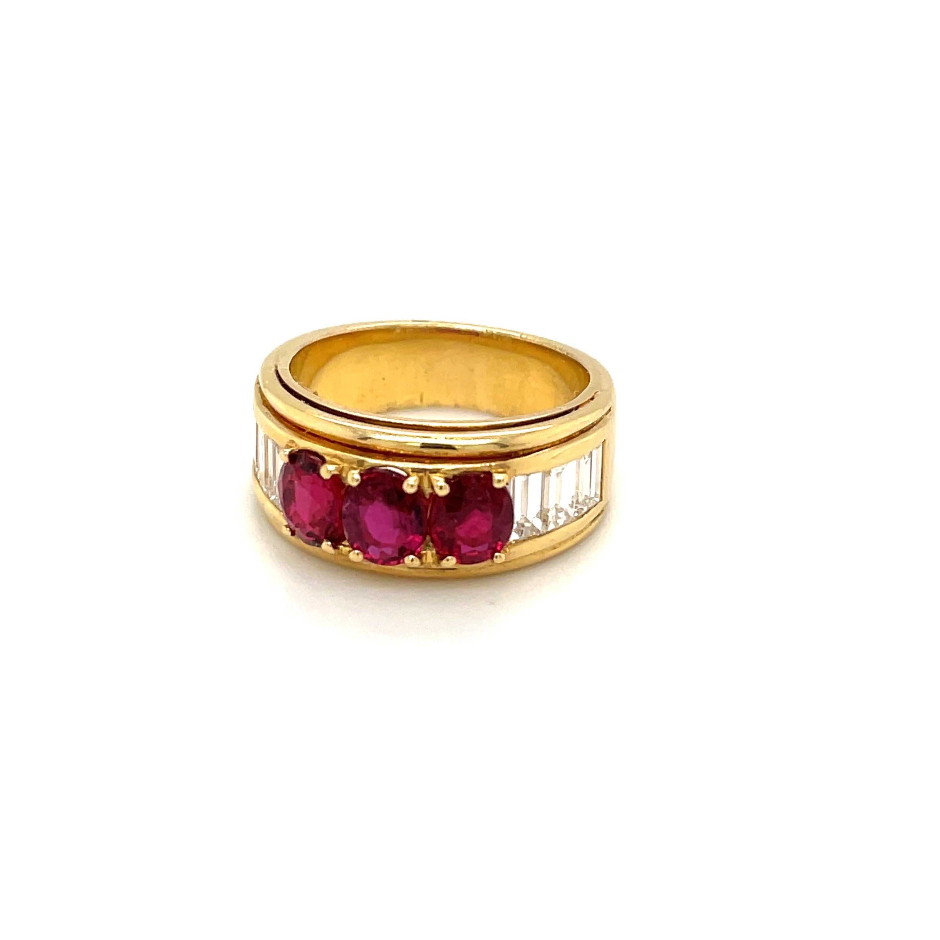 Crafted by the famed Italian designer Guiseppe Picchiotti, this ring is a perfect example of his meticulous work. Set in 18 karat yellow gold this ring features 3 oval rubies set across the top . Three baguette diamonds flank the rubies on either