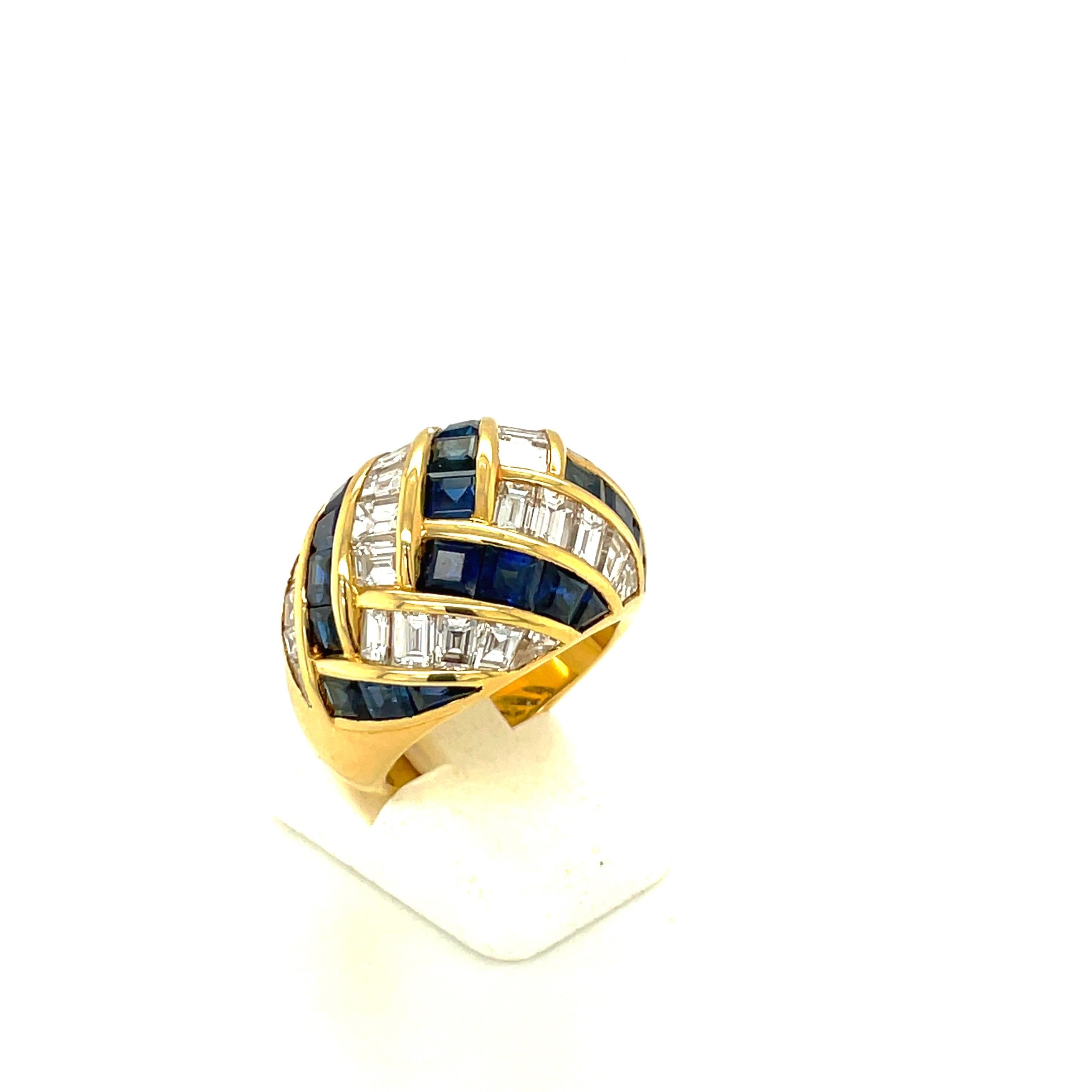 Crafted by the famed Italian designer Guiseppe Picchiotti, this ring is a perfect example of his meticulous work. Designed in 18 karat yellow gold this ring is beautifully set with alternating baguette cut diamonds and square cut blue sapphires in