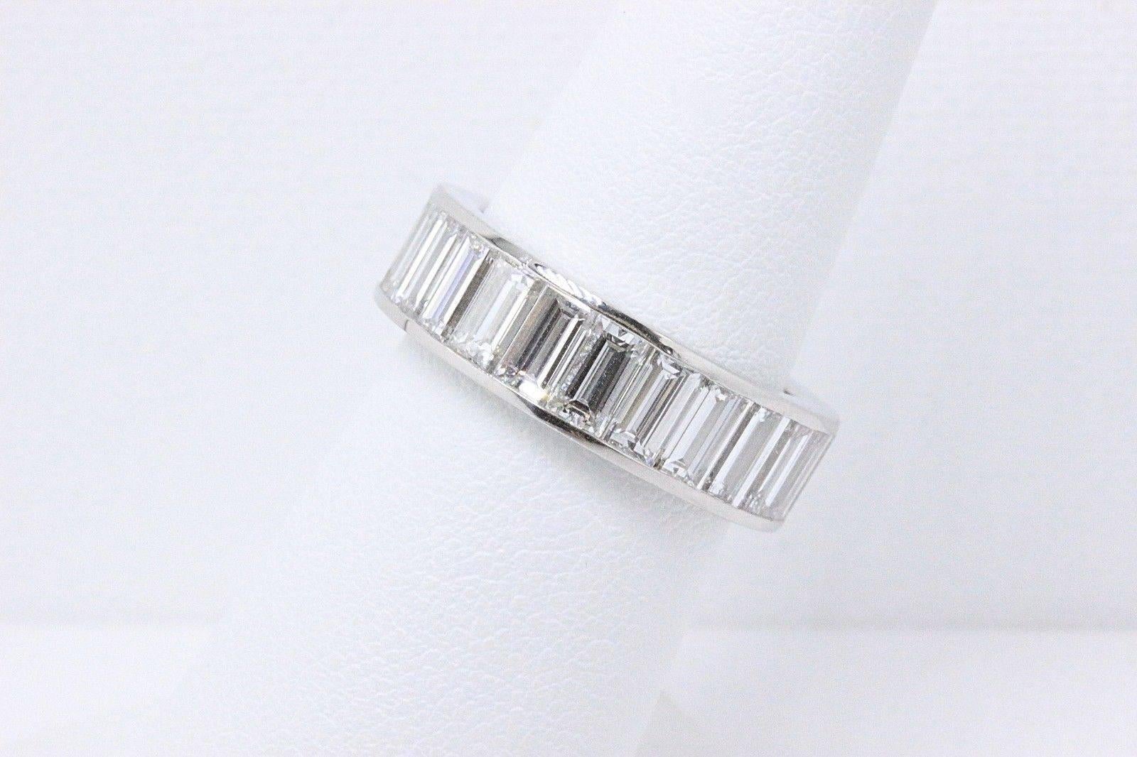 Picchiotti 
Baguette Cut Channel Set Diamond Eternity Band in Platinum.  
There are 24 Baguette Diamonds weighing 5.50 TCW F - G color, VVS clarity.  
The width is 6.5 MM wide.  
Size 6.5.  
Hallmark 