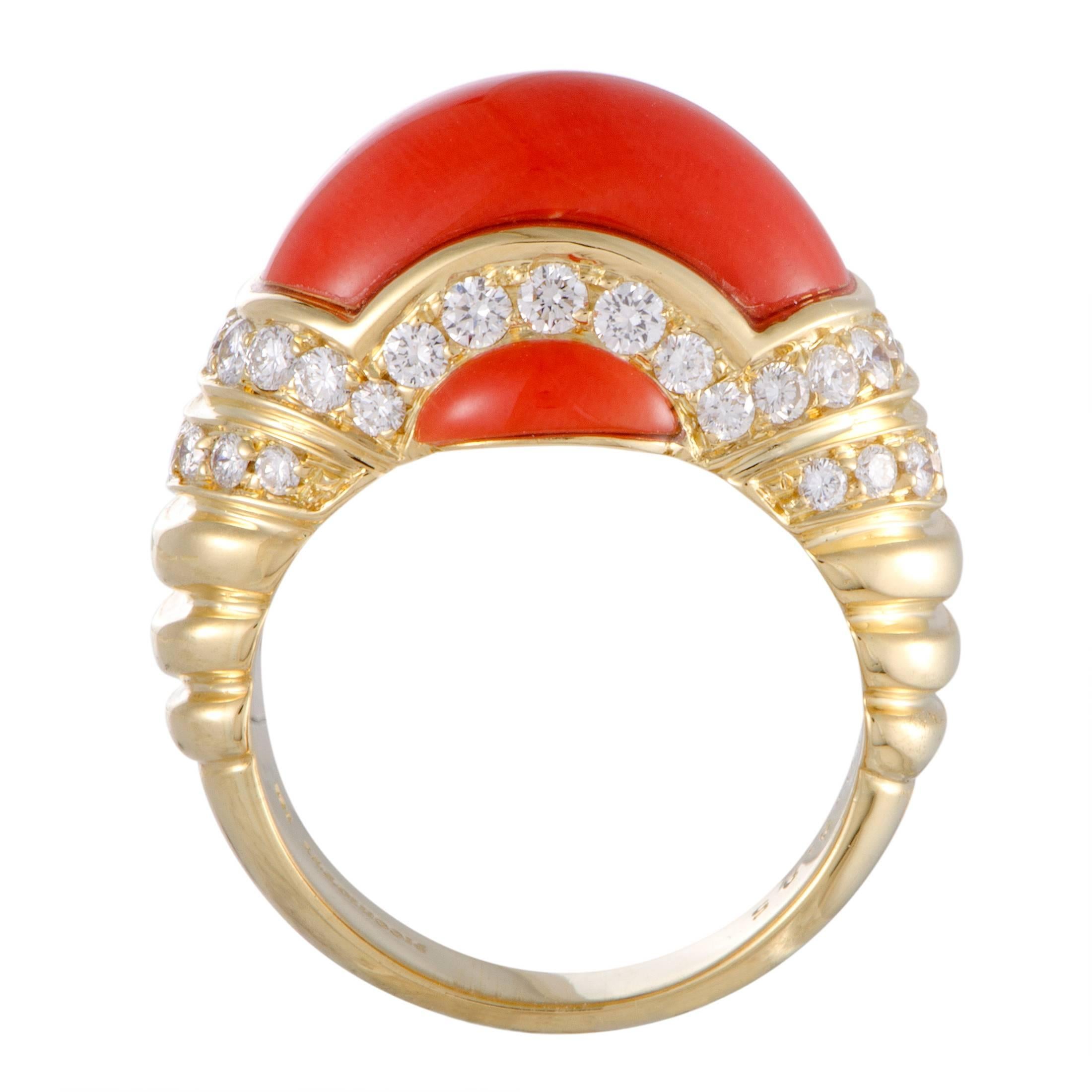Providing a stunningly fabulous and tastefully complementing backdrop to the astounding color and gracefully smooth shape of the spotless coral stone, the radiant 18K yellow gold is also adorned with 0.85 carats of lustrous F color diamonds of VS1