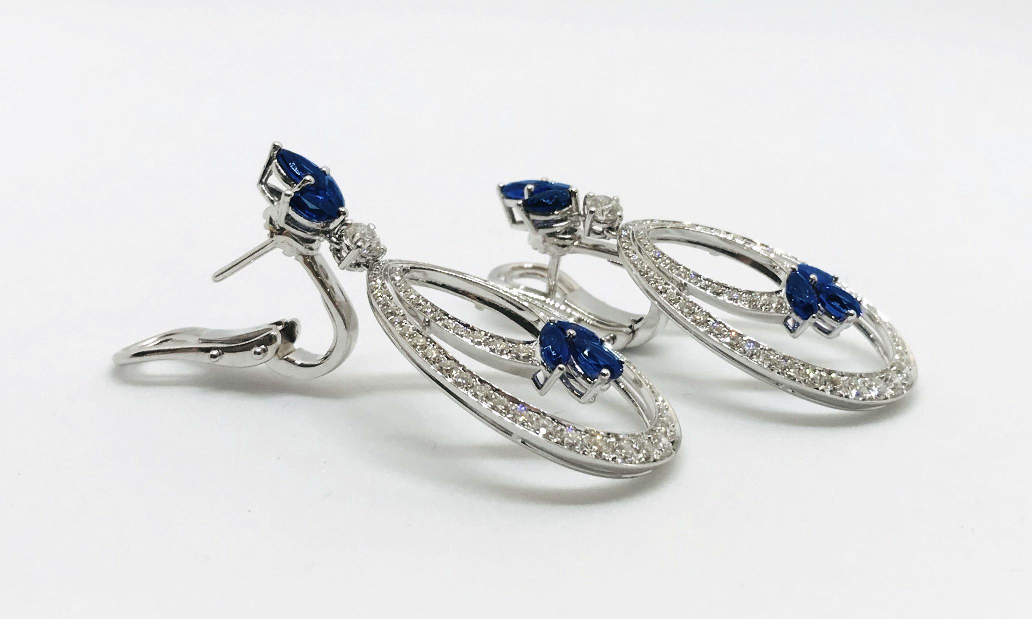 Picchiotti 2.13 carats diamond and 3.34 carats blue sapphire drop earrings with clip and retractable post. The 
top is a cluster of 1-pear- and 2-marquise-cut sapphires with a single round diamond from which hang double, pear-shaped rings,
