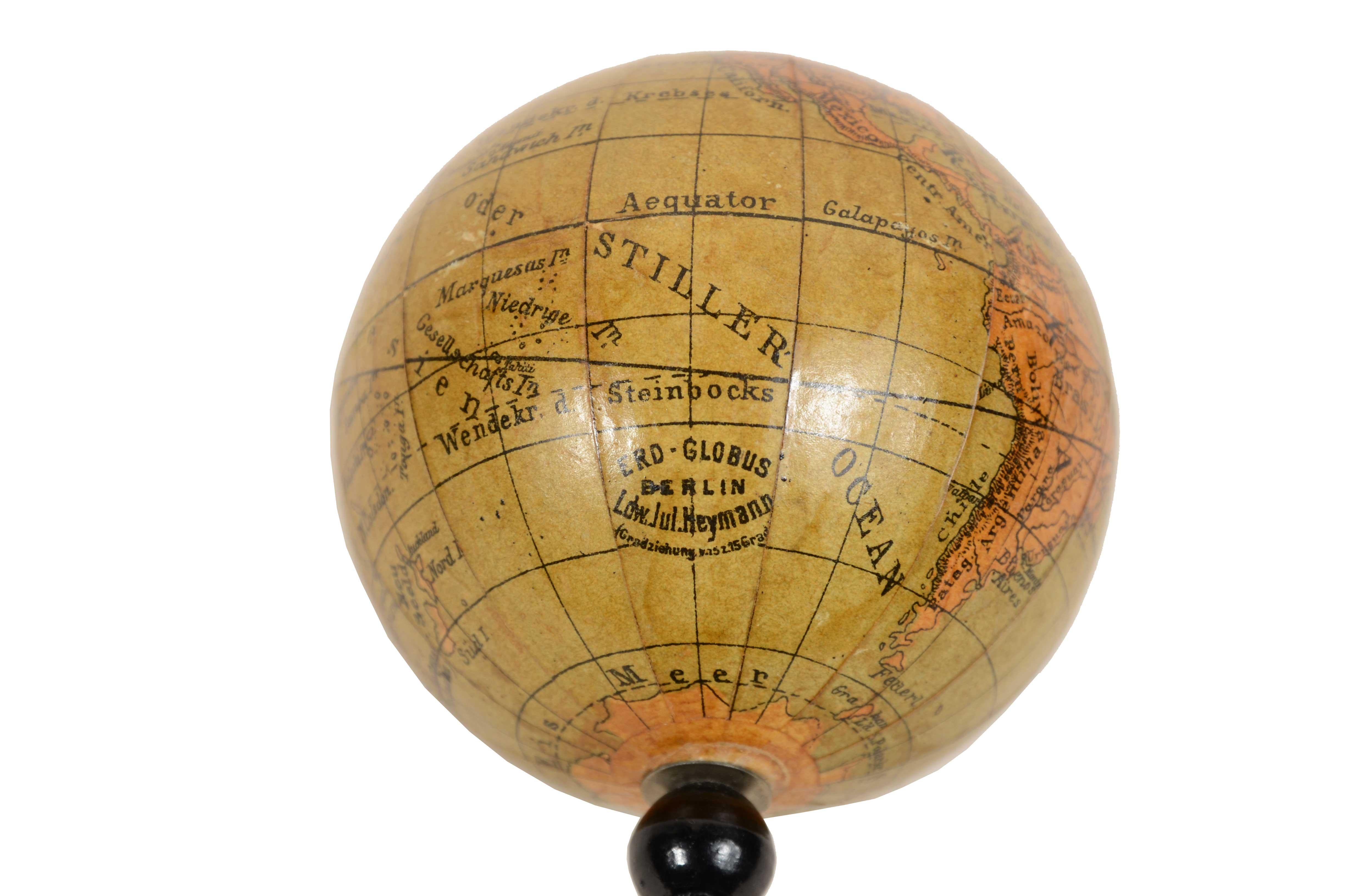 Small globe published in the second half of the 19th century by cartographer Ludw. Jul. Heymann. Papier maché ball and turned and ebonized wood base. 
Height cm 16,- inches 6.5, sphere diameter cm 7 - inches 2.8. 
Good state of preservation.