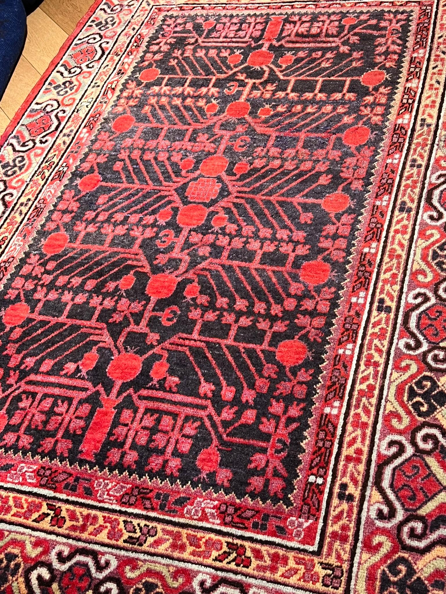 Wool Small Yarkand rug decorated with pomegranate tones of cochineal red and gray For Sale