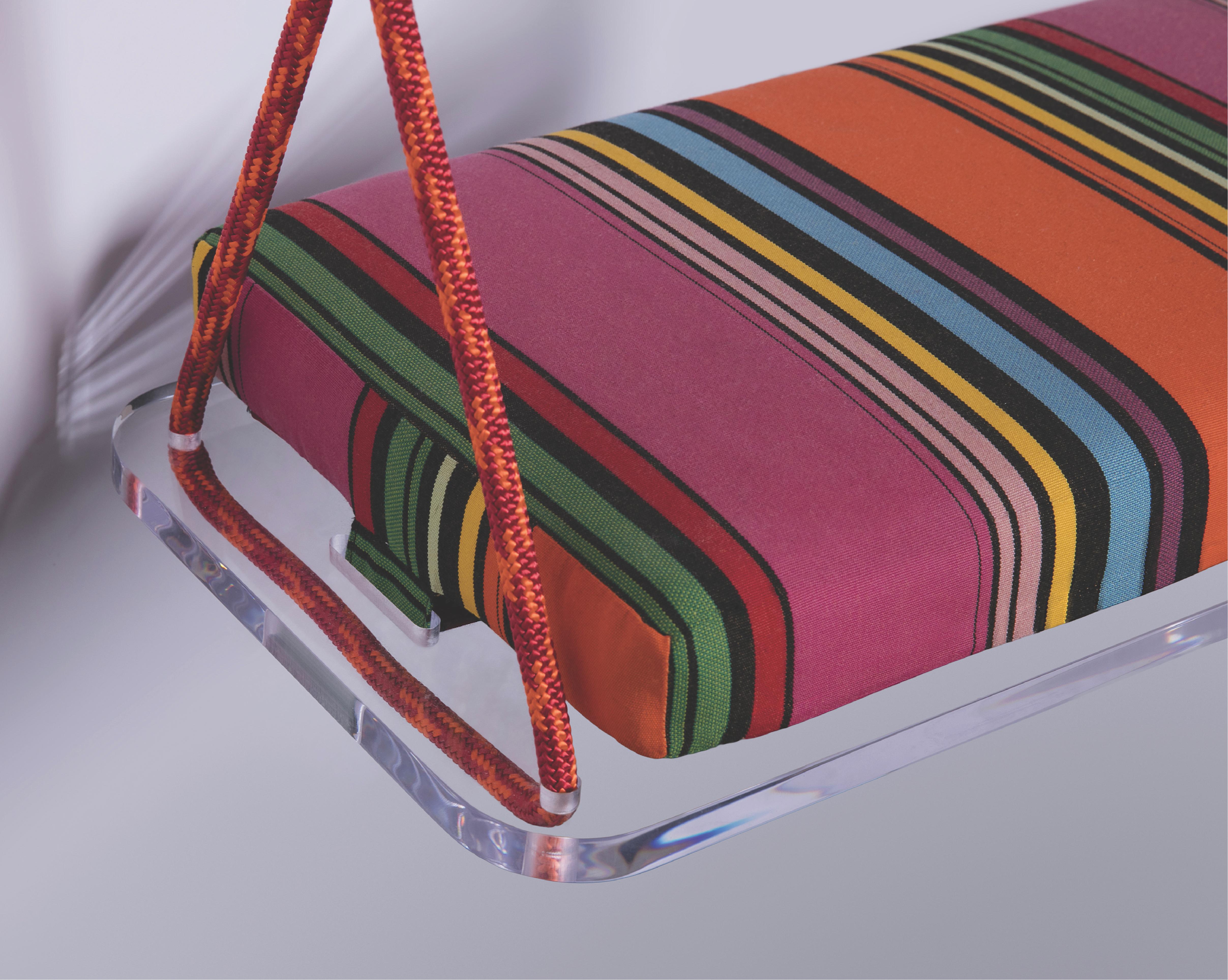 The Pick-Me-Up Single seat swing is a playful indoor and outdoor swing featuring a striped Sunbrella cushion, colorful accessory cord, a Lucite base and Lucite accessories. Featured here is a vintage inspired striped Sunbrella, however, there are a