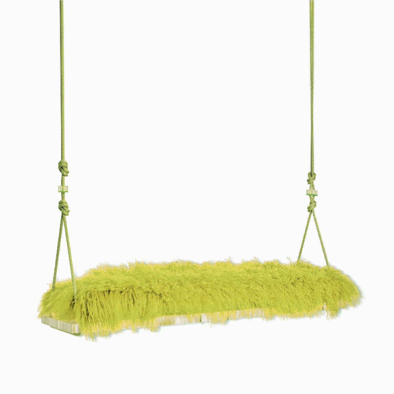 The pick-me-up swinging bench is a playful indoor swing for two featuring a Tibetan Lamb cushion, colorful accessory cord, a lucite base and lucite accessories. Featured here is a bright Chartreuse, however, there are a variety of Tibetan Lamb