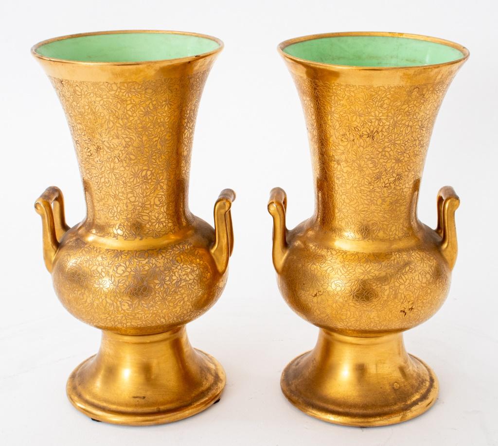 Pickard porcelain gold-encrusted campagna-form two-handled urns, a pair, allover decorated with floral incised motifs, the interiors glazed pistachio green. 8.5