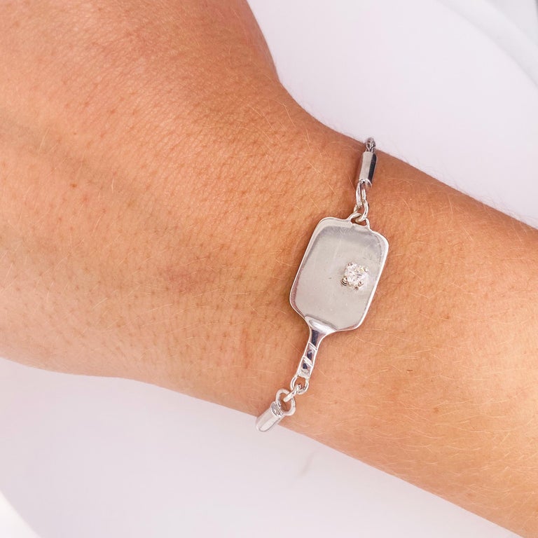 PICKLEBALL JEWELRY has never been so popular! His bracelet is made so that you can wear it out on the court.  It is handcrafted in the finest .925 silver and has a gorgeous .13 carat round brilliant diamond on it. All components are made of sterling