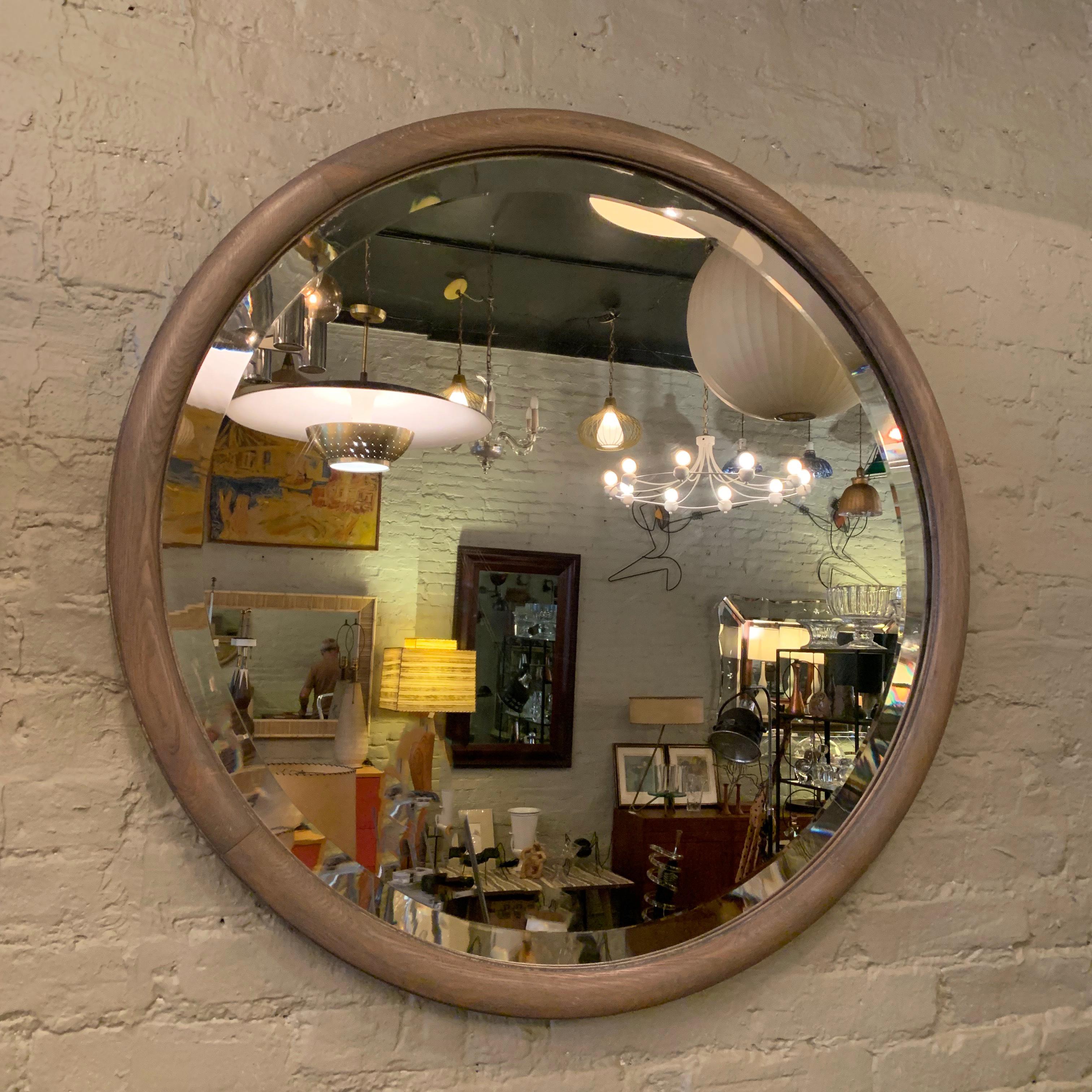 Large, round, oak framed mirror newly restored in a pickled finish. The mirror features a double beveled edge.