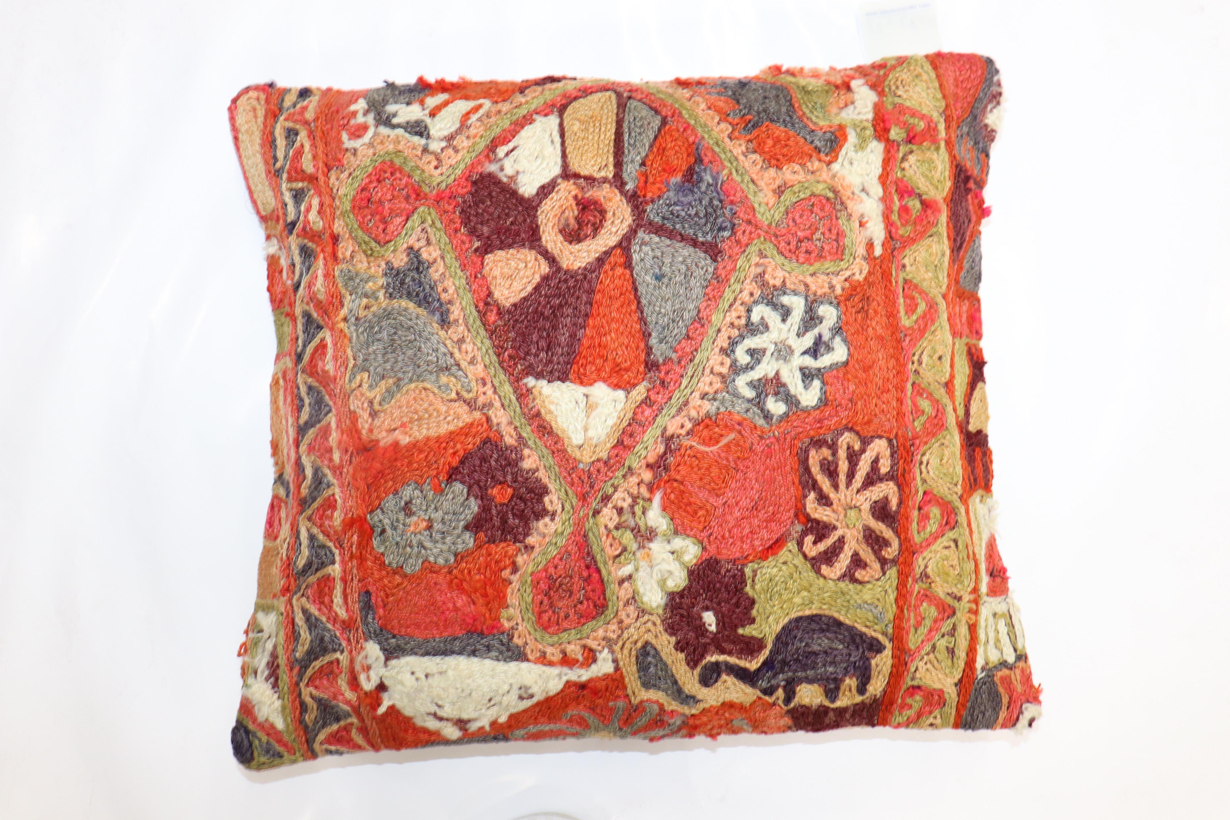 Pillow made from a chain stitch african textile. Cotton backing, polyfill insert provided

18'' x 21''