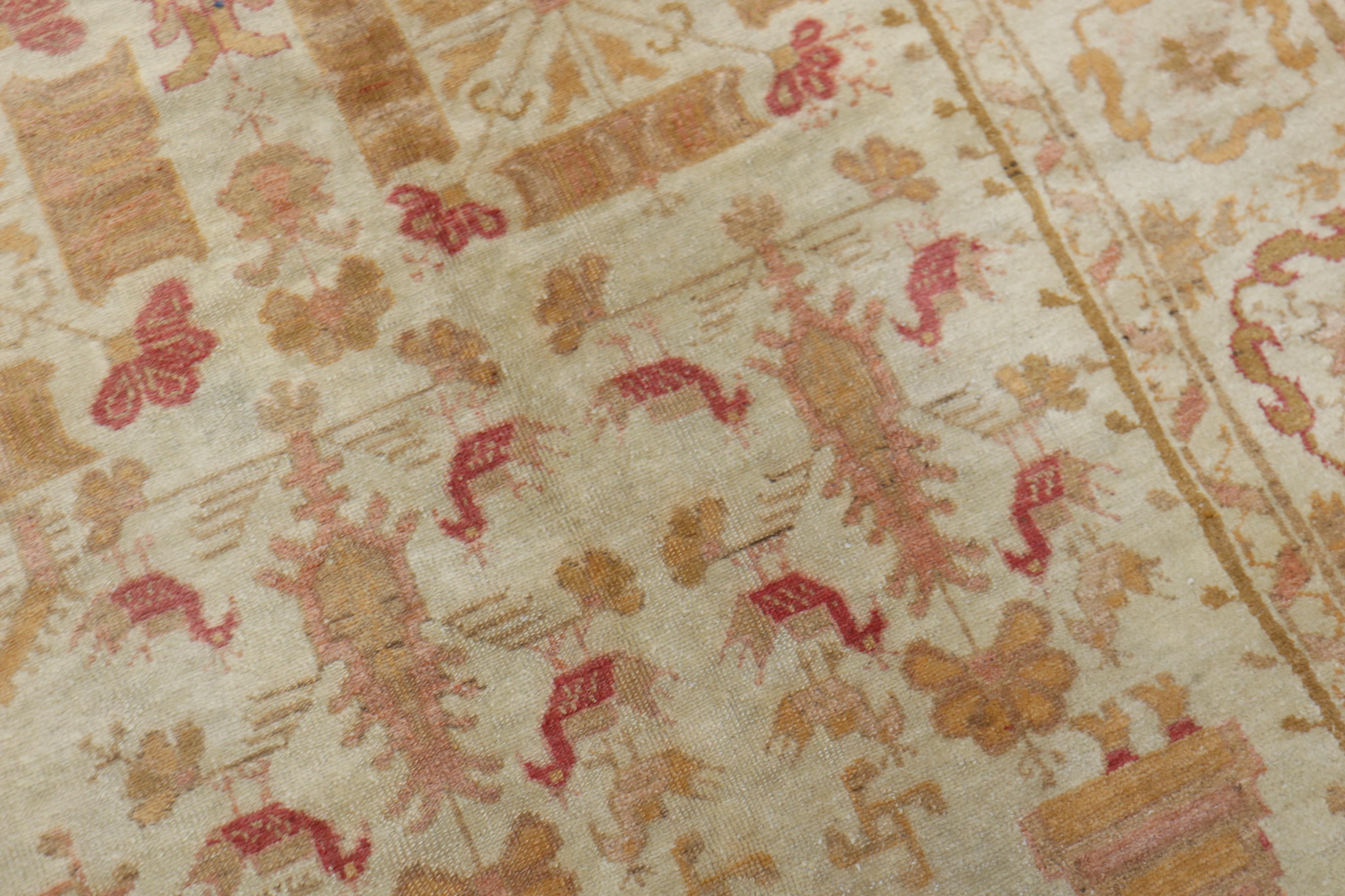 An early 20th-century Turkish Oushak rug with a pictorial bird and small palmette all over design on an ivory field. accents in pink, orange, brown.

Measures: 9'2