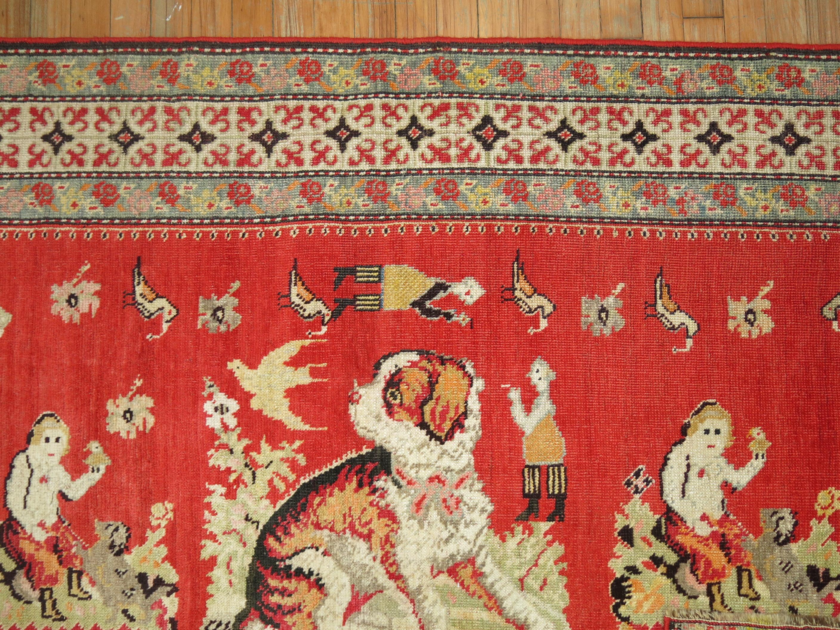 A pictorial rug depicting a dog floating around different human, animals and figures on a red ground.