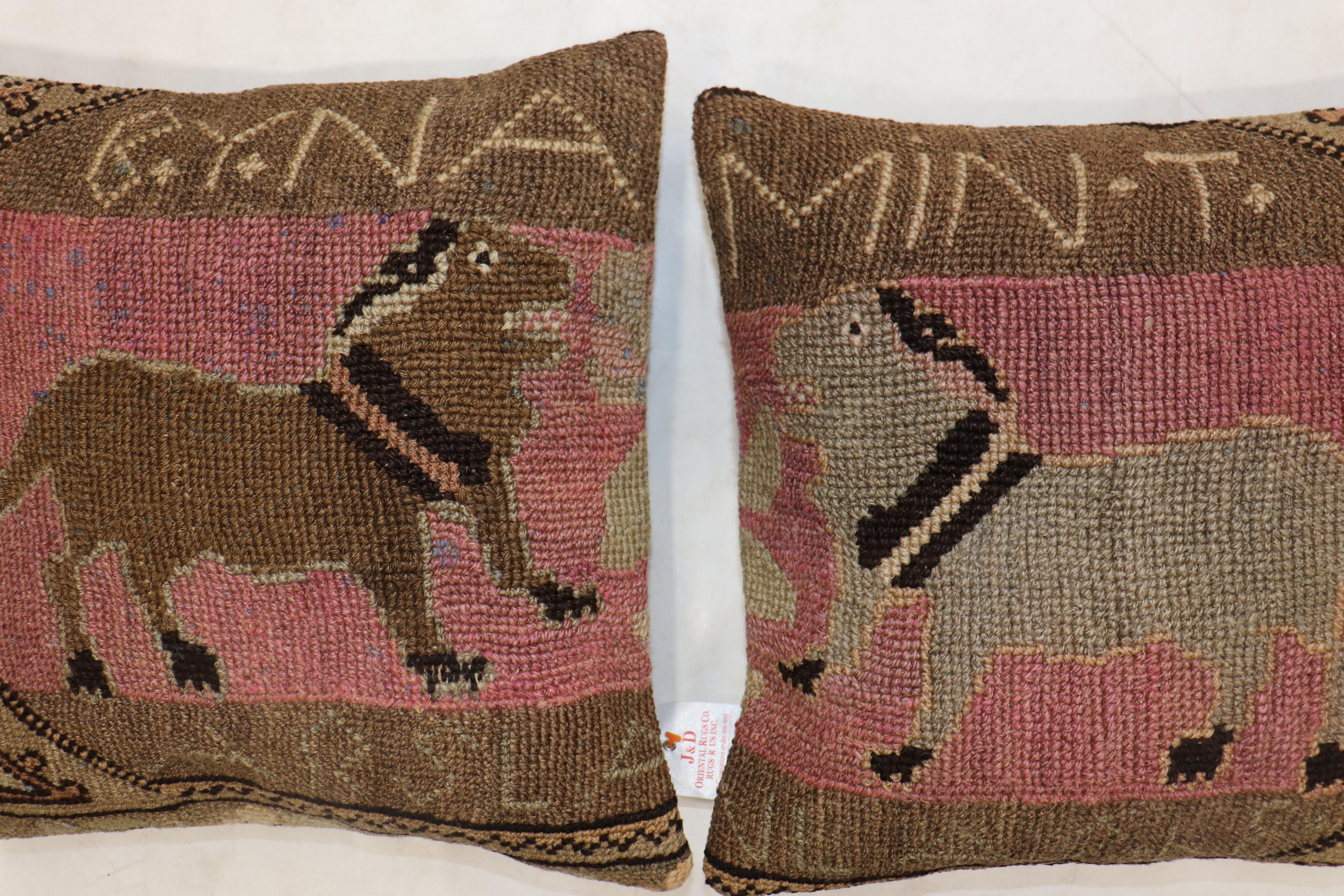Set of pillows made from a mid-20th century Turkish wool rug depicting 2 dogs. There are Turkish names of each dog inscribed on each pillow. Probably given as a gift.

Measuring: 16” x 16” respectively.