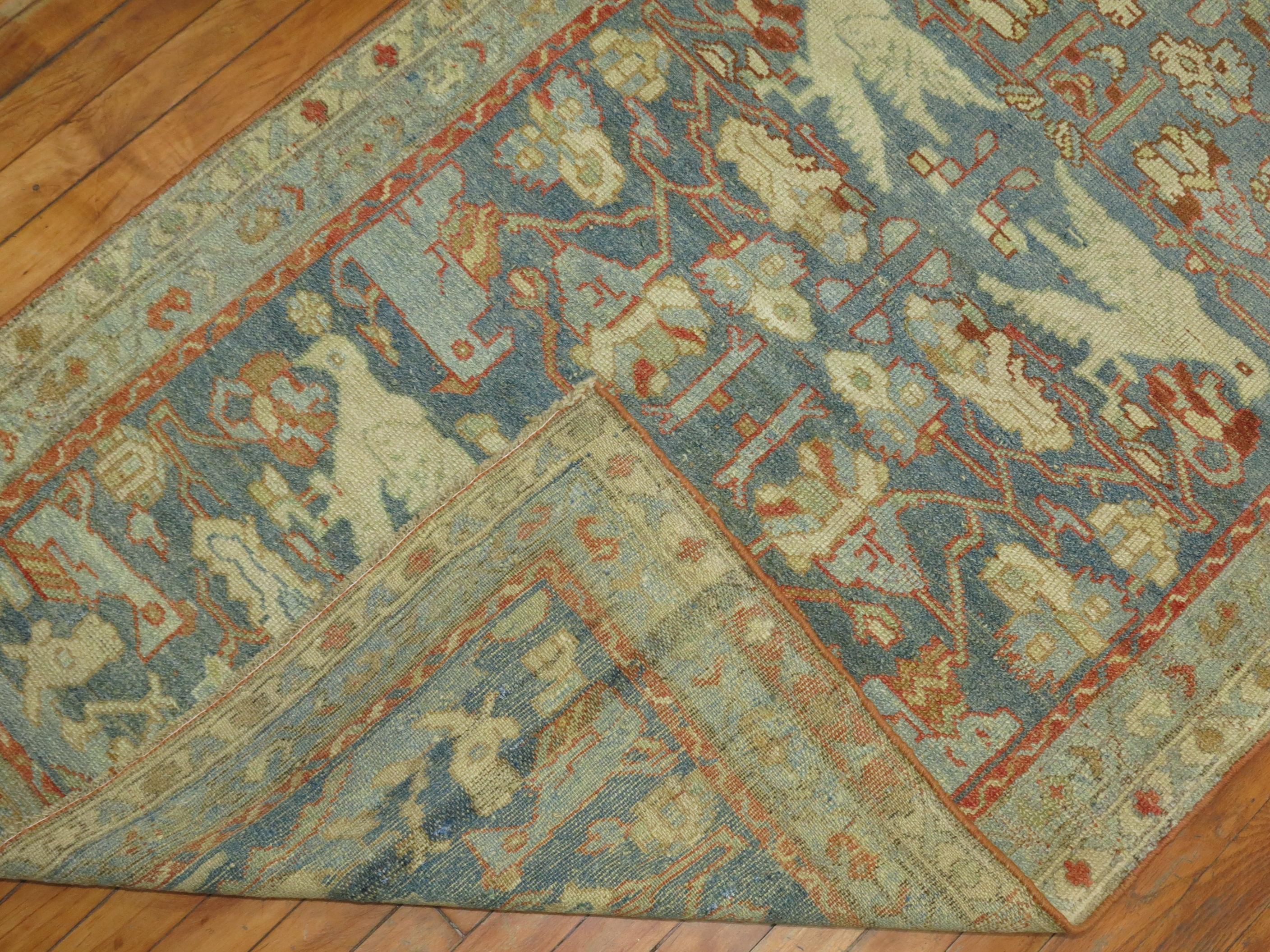 A decorative pictorial Persian Malayer Runner with a flurry of white and blue birds and pigeons on a soft blue background, circa 1920.

 