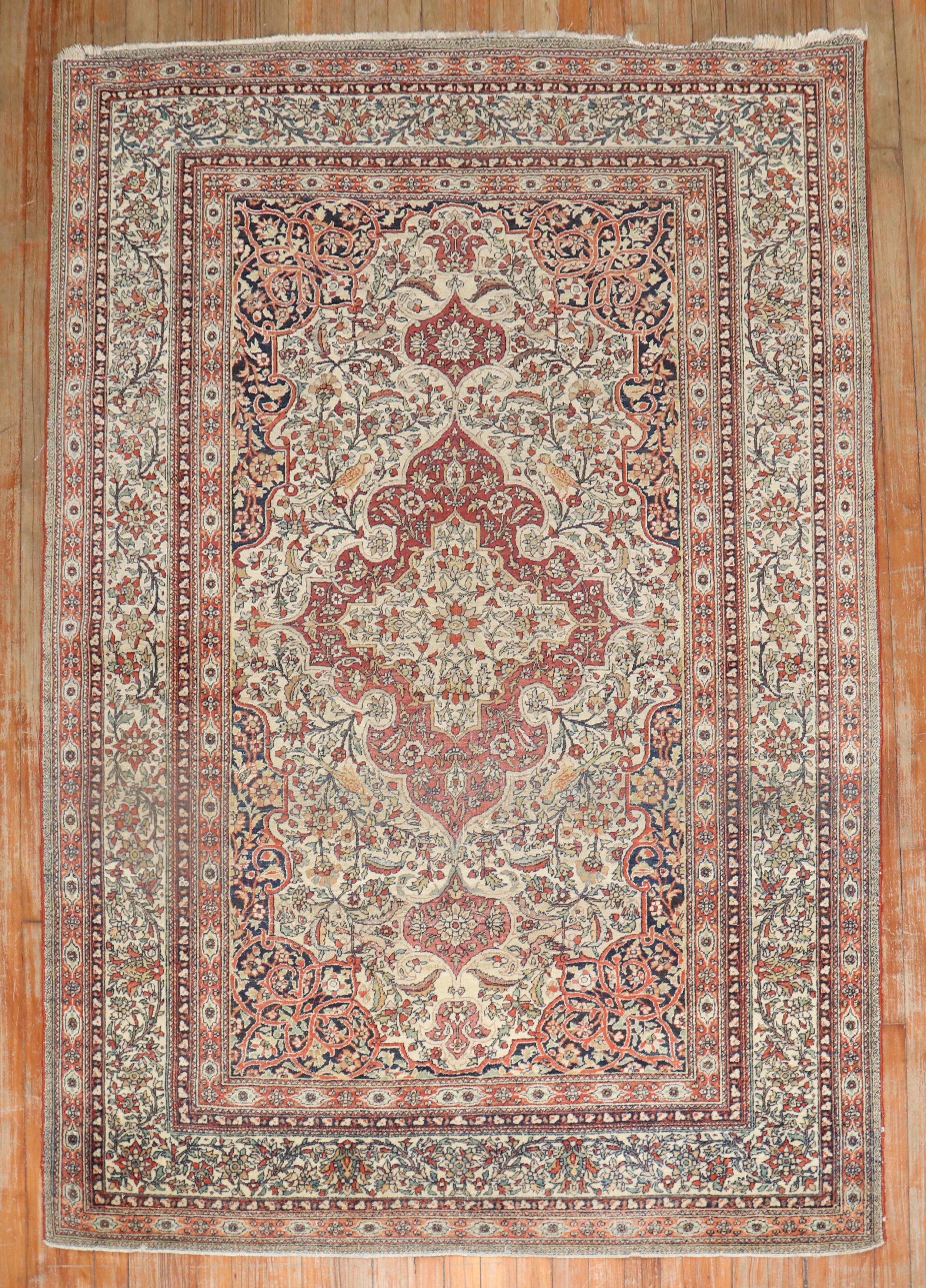 Fine quality early 20th century Persian Isfahan carpet with a Classic tradtiional design in ivory, rust, red and navy tones.

Measures: 4'7'' x 6'7''.