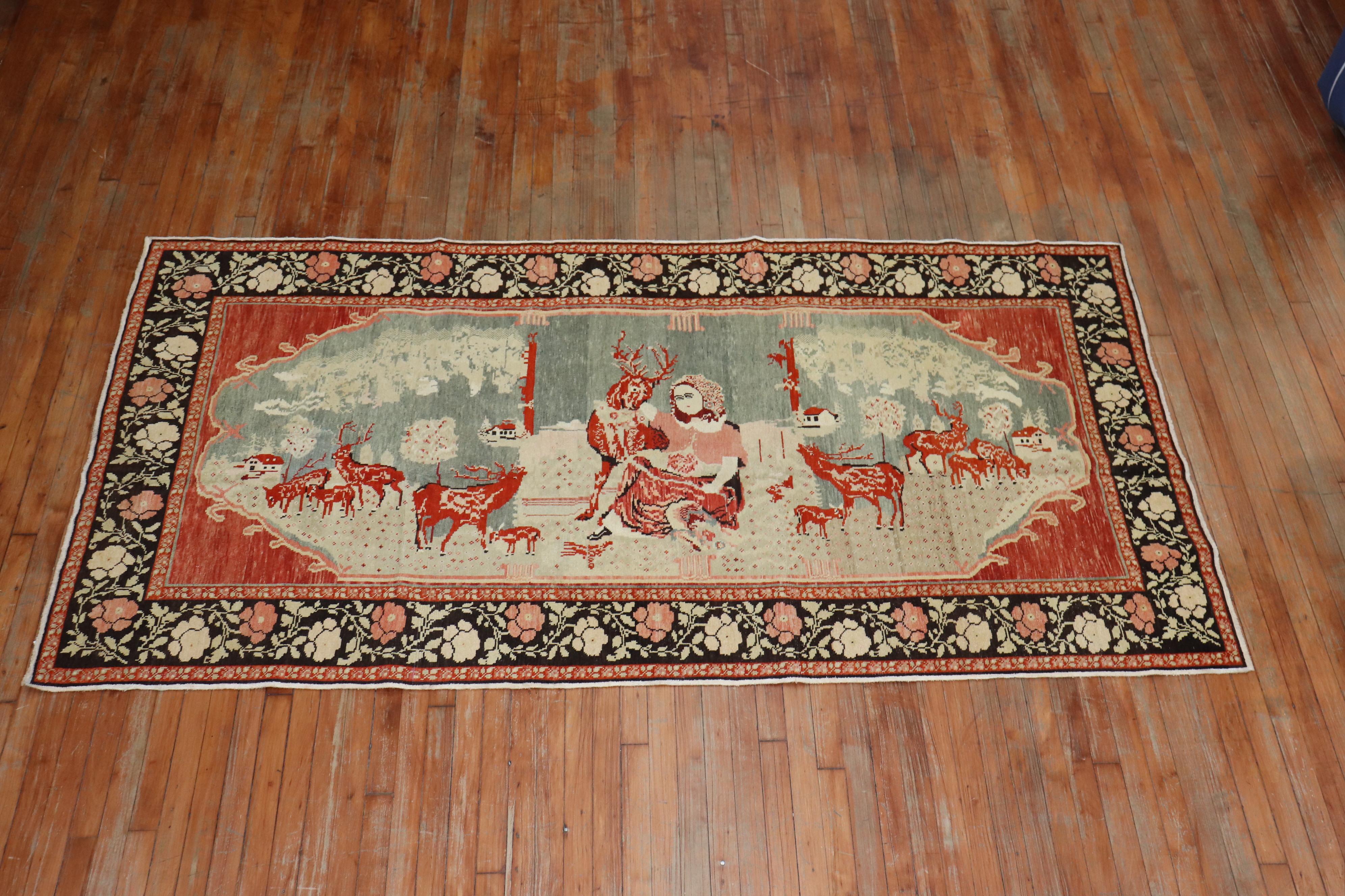 A pictorial Russian Karabagh rug depicting a bunch of reindeers floating around a lady. The background is a tomato red, the border has a floral motif in dark brown,

circa 1940. Measures: 4'6