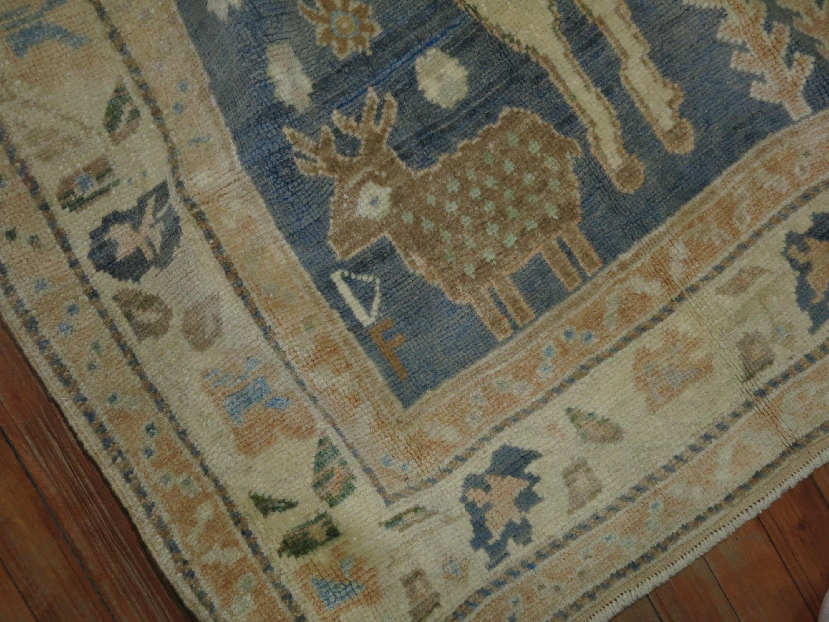 A highly decorative mid-20th century Turkish rug with 2 large sheep on a casual gray blue sea foam colored ground. Smaller birds and sheep hovering around the field too.

Measures: 4'6'' x 7'2'' circa 1940.