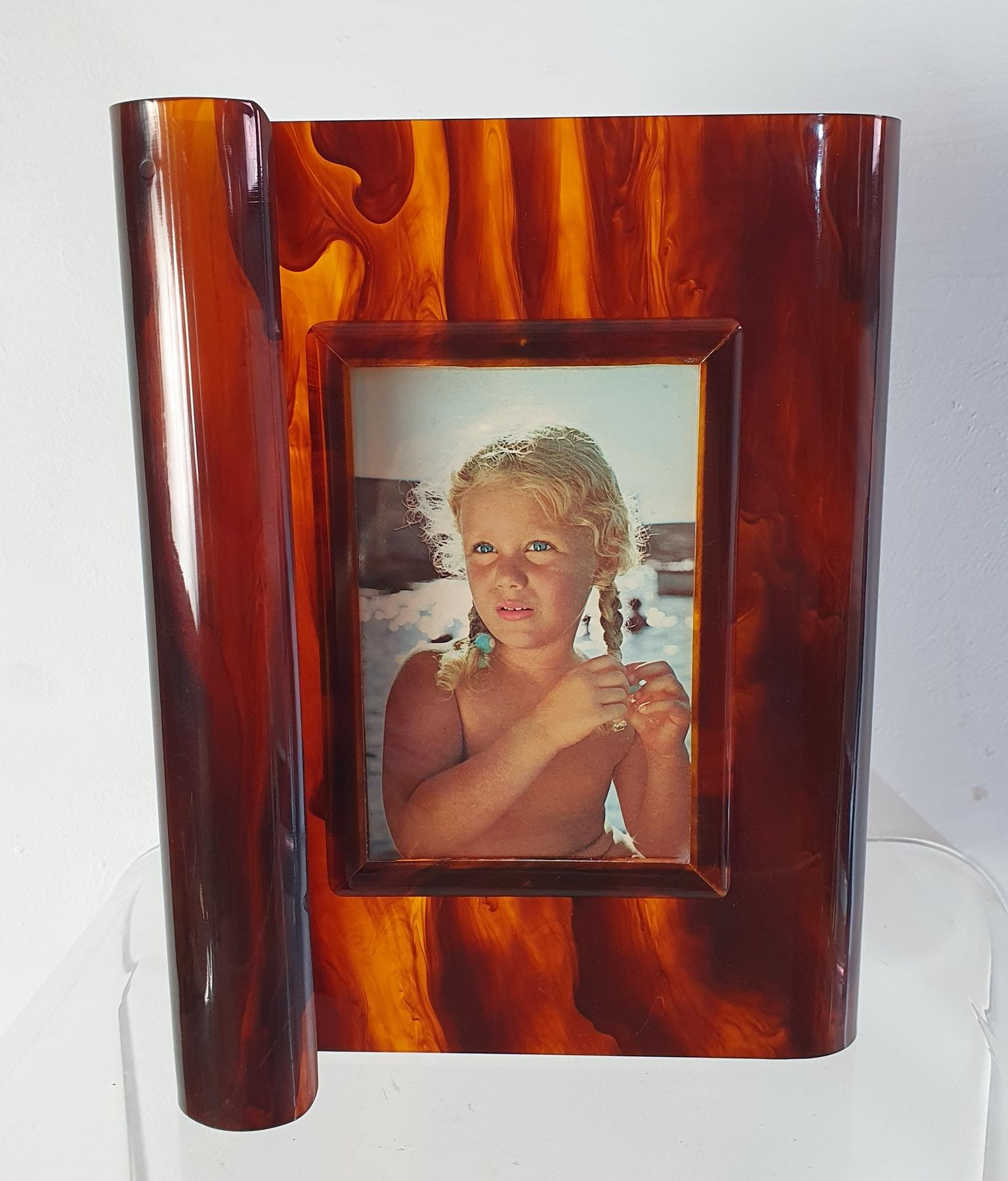 Art Deco style photo/picture frame in lucite faux tortoiseshell lucite with an S curved design. This piece seems to never have been used and appear as new. In very nice condition without scratches or breaks.