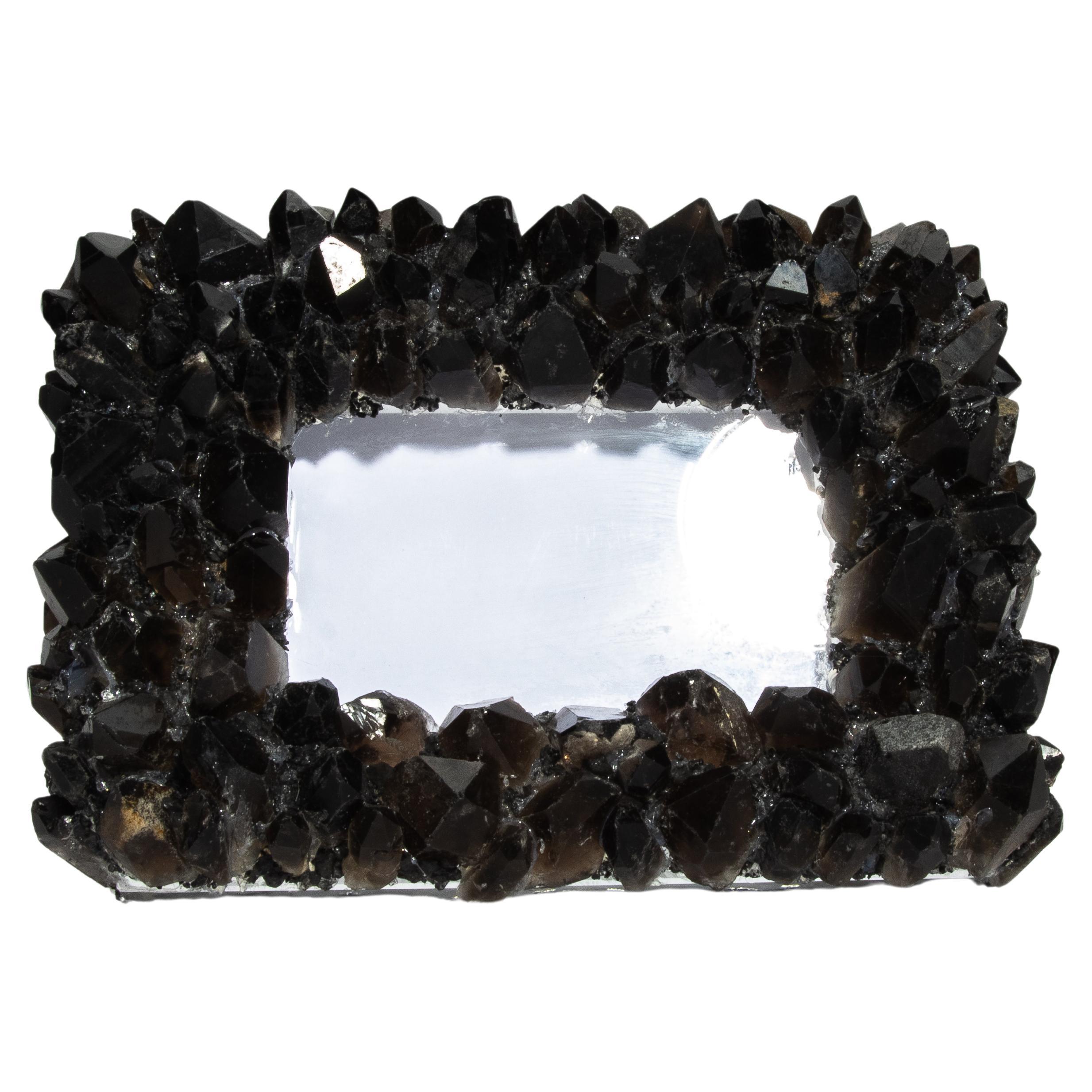 This Kathryn McCoy frame, adorned with black quartz crystals, is a perfect blend of elegance and natural beauty. The frame showcases the intricate structure and deep, rich tones of black quartz, making it a standout piece for any home or office.