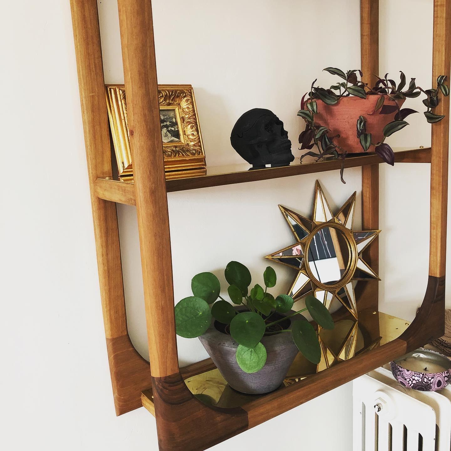 A handsome wall hung shelving unit hand made with the finest French walnut wood. The rectangular picture frame façade makes this item uniquely stand out in a room and the polished brass shelves add a touch of class. The wood is treated with a