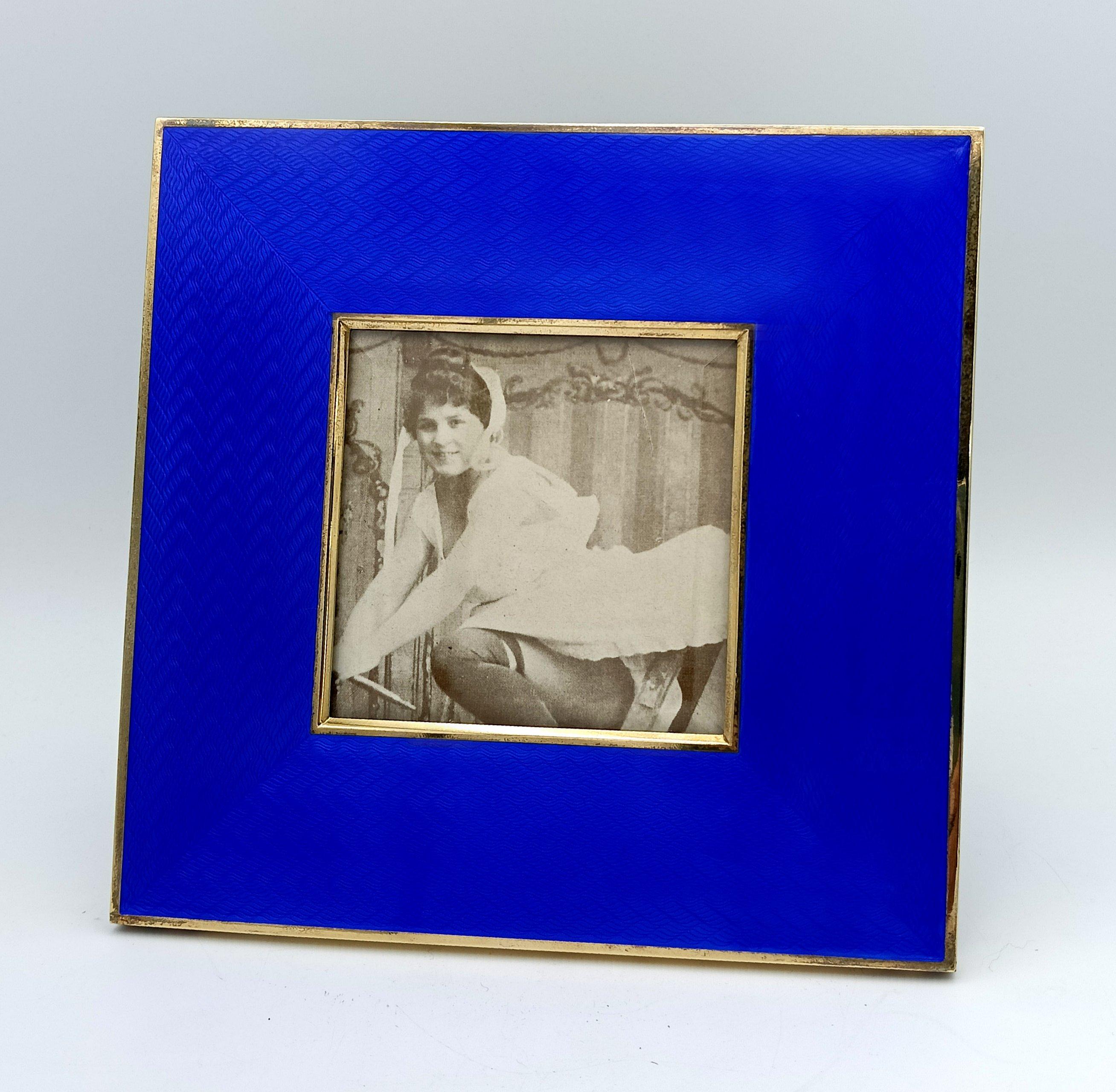 A Modern Heirloom: Large Square Guilloché Enamel Frame by Giorgio Salimbeni

Presented is a commanding and radiant square photo frame, a masterwork of contemporary Florentine jewelry arts applied to object design. Executed in lavish gold-plated