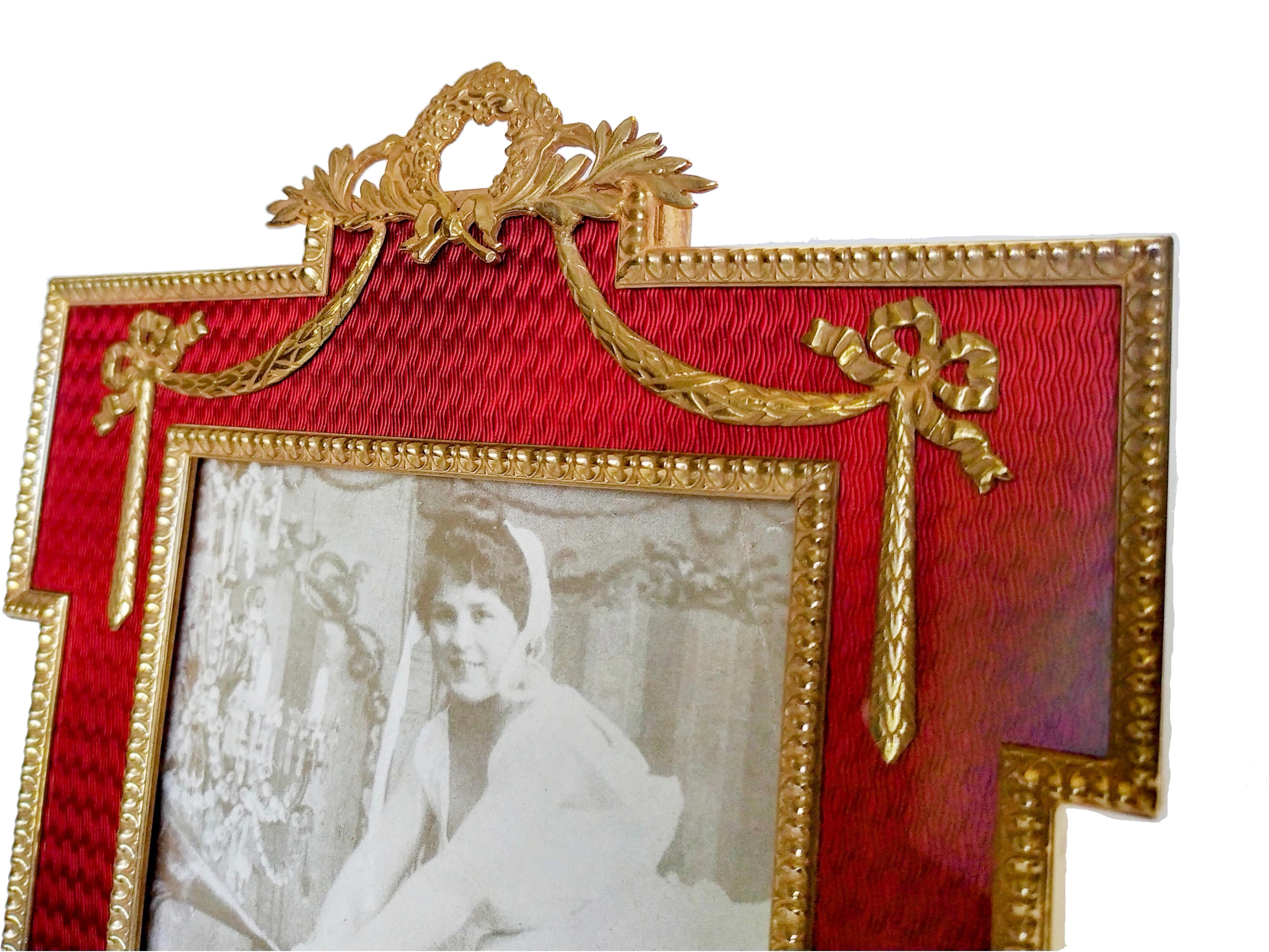 Behold the epitome of elegance and craftsmanship: a square table photo frame, meticulously crafted from 925/1000 gold-plated sterling silver. This masterpiece features translucent fired enamel on guilloche, with an internal border adorned with