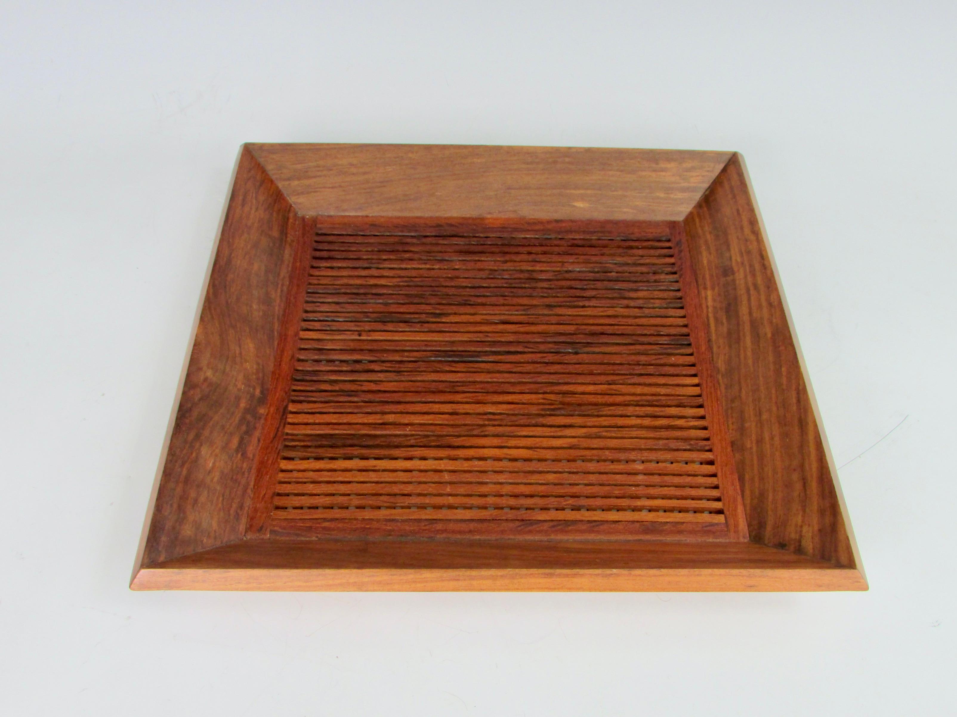 Finely crafted tray of criss crossed rosewood strips set in rosewood picture frame style border . 