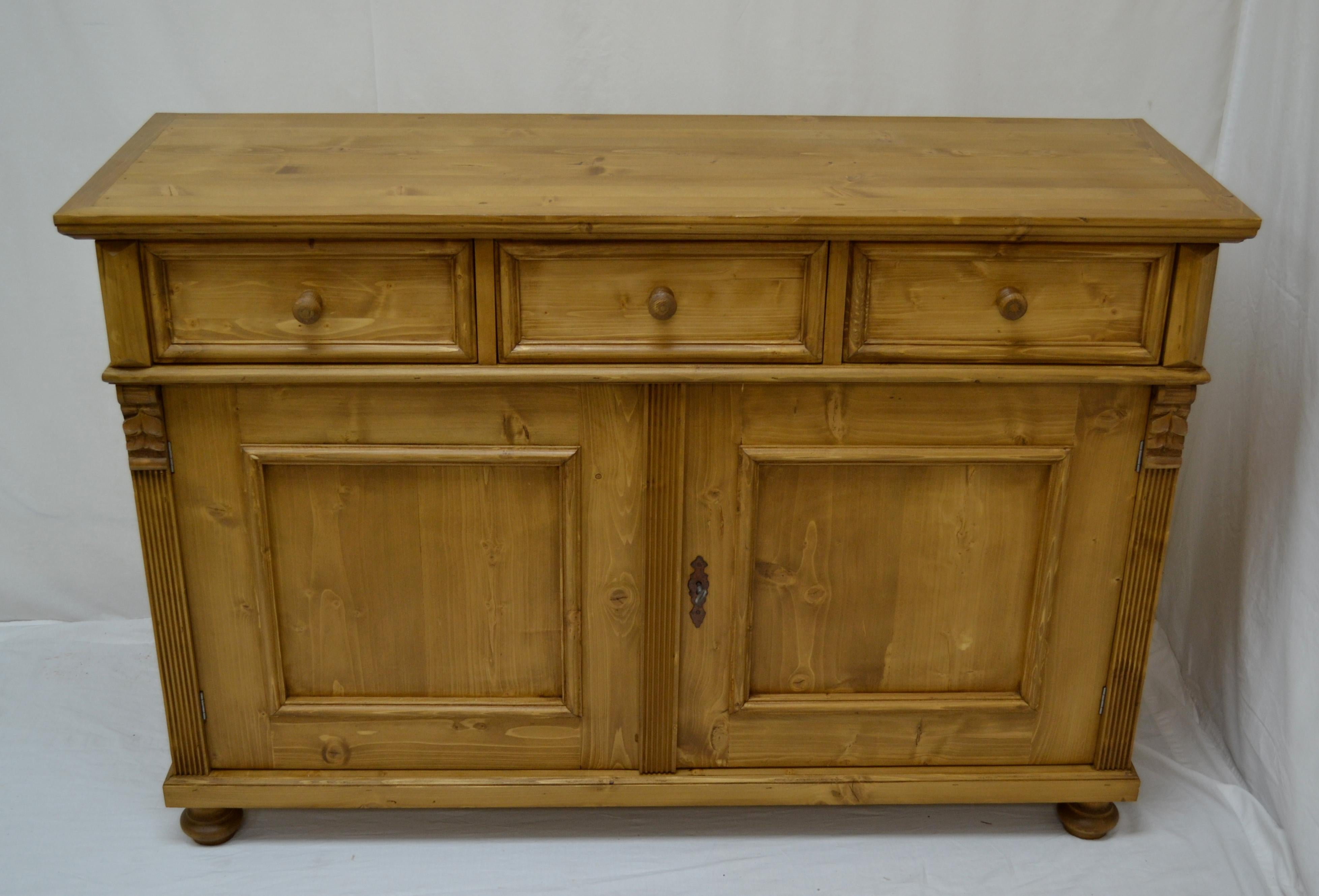 This is a shorter version of a popular pine mine sideboard design, this one with two doors and three drawers. Built in central Europe from reclaimed pine, this most versatile piece works well as a single or double vanity in the bathroom, as a base