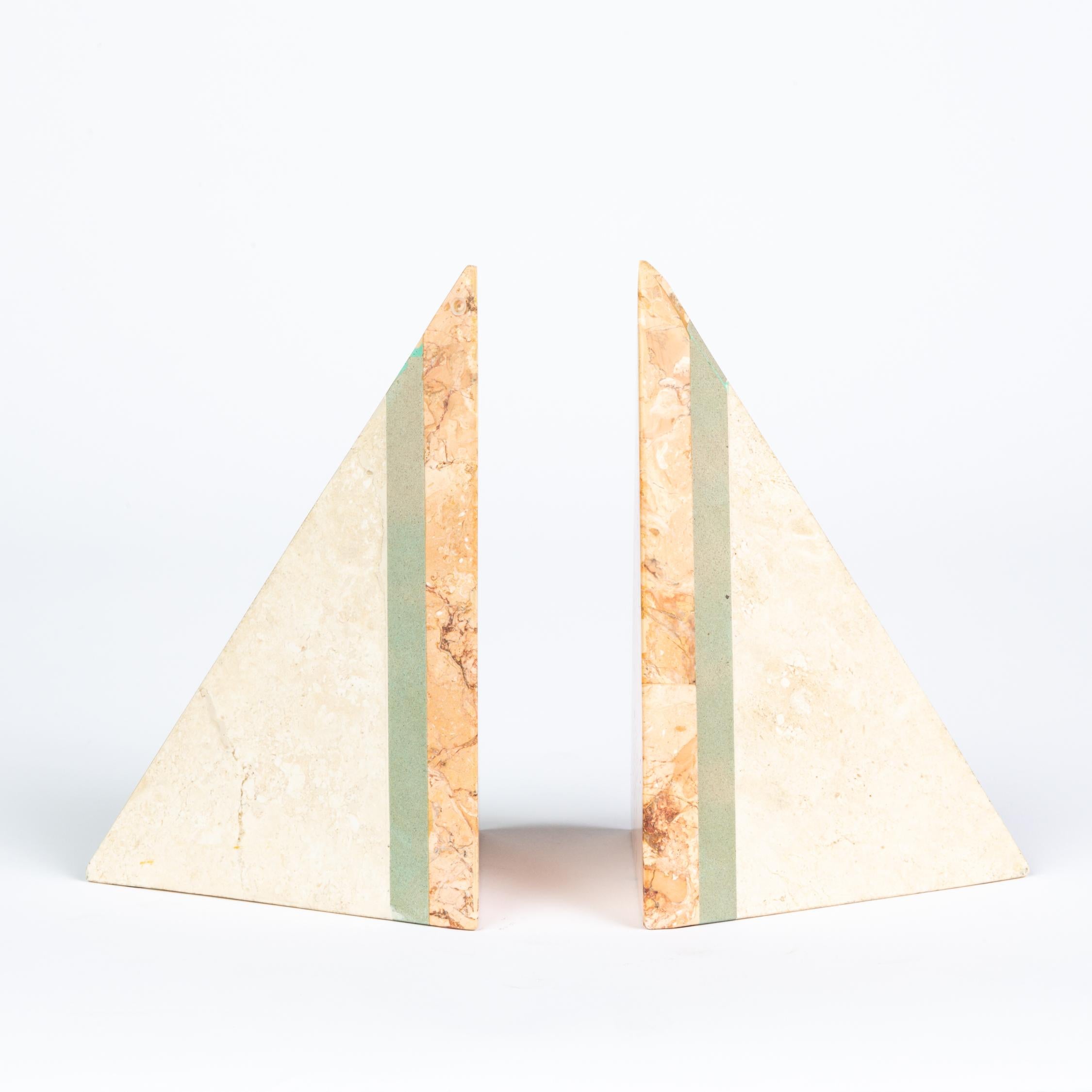 Huntington Beach, CA-based Renoir Designs specialized in tessellated and pieced stone home accents like decorative boxes and bookends, as seen here. This pair of tetrahedron bookends have three layers of colored marble in pink, green, and off-white