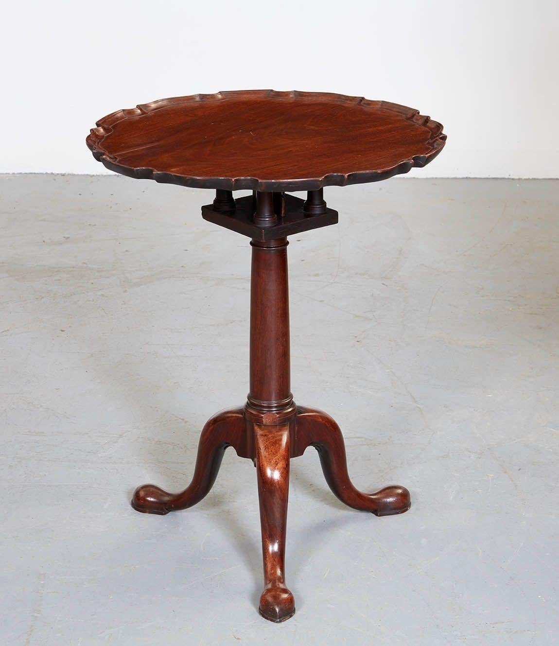 Fine George II mahogany pie crust tea table, the well-figured scalloped and dished top over original birdcage tilt mechanism, on cannon-barrel turned shaft and standing on graceful slipper fee, the whole with good rich color and patination.