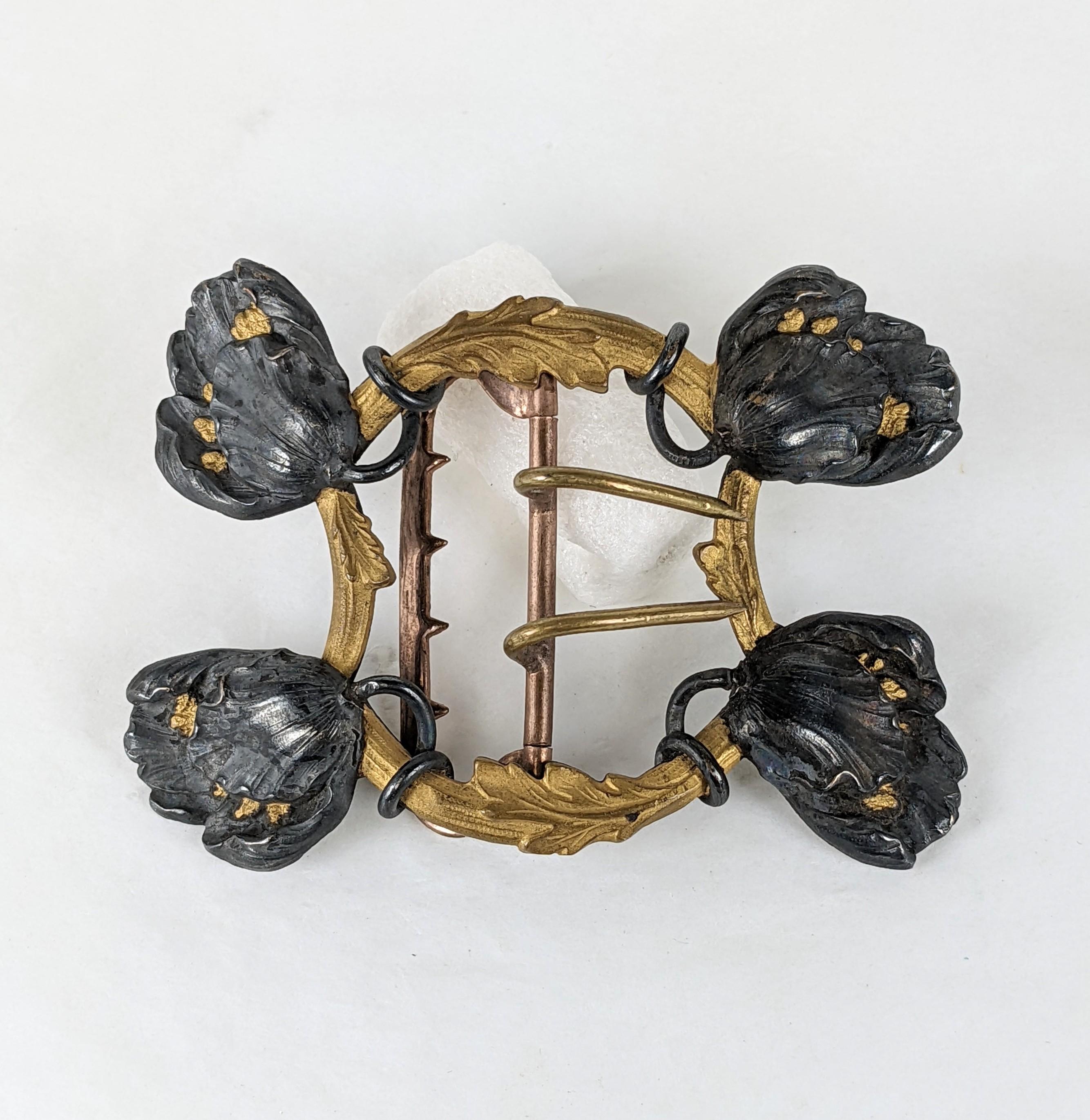 Piel Frères Art Nouveau double prong buckle circa 1900. Of rich matte gilt bronze foliage and japanned silver plated blooming poppies with matte gilt detailed pistons. Gold plate buckle fittings.
Excellent Condition.  Unsigned.  L 3 1/8